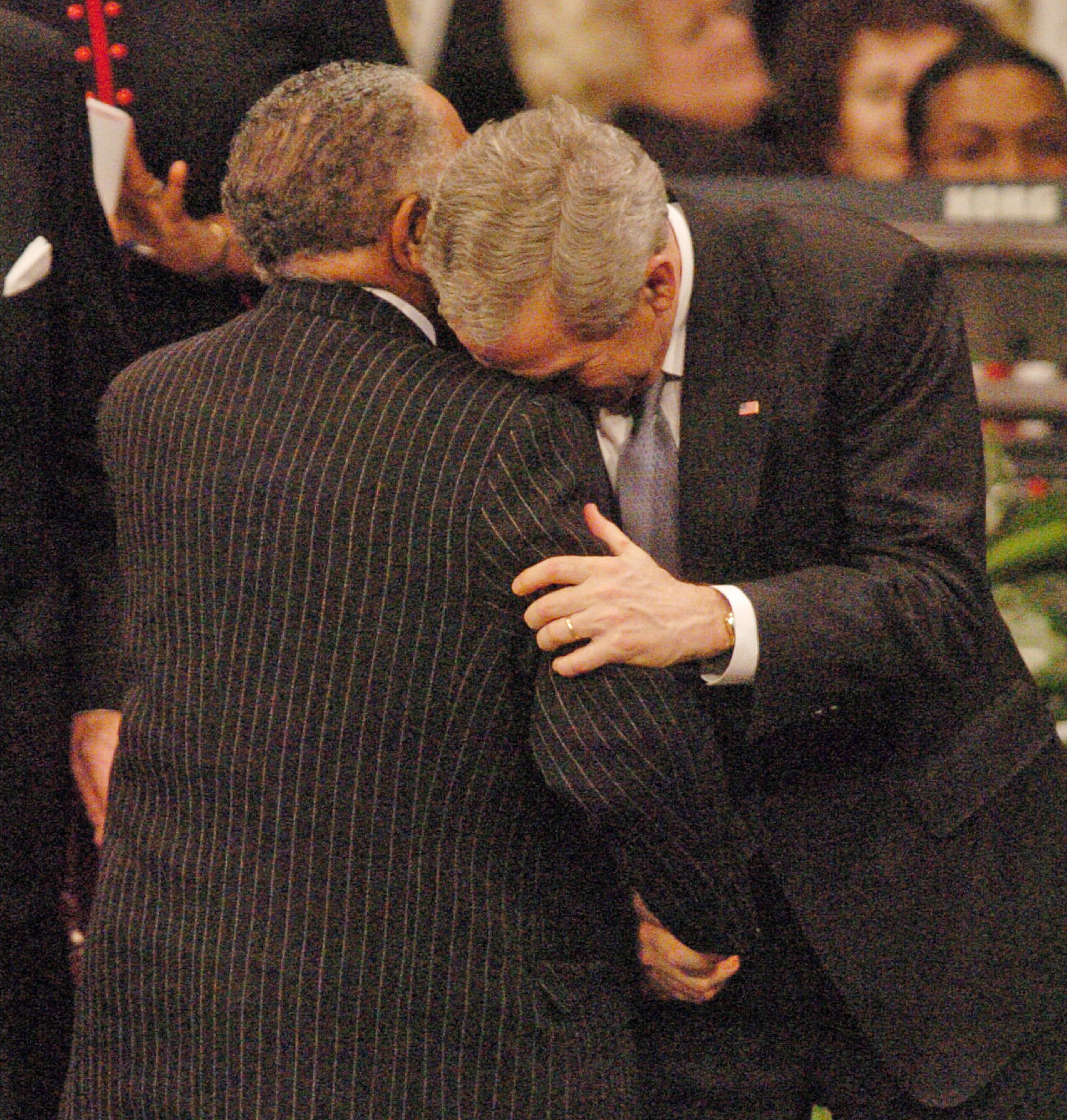 President George Bush rests his head on the shoulder of Rev. Joseph Lowery at the funeral service for Coretta Scott King, wife of Dr. Martin Luther King, Jr., on Feb. 7, 2006. (RENEE HANNANS HENRY/AJC staff)