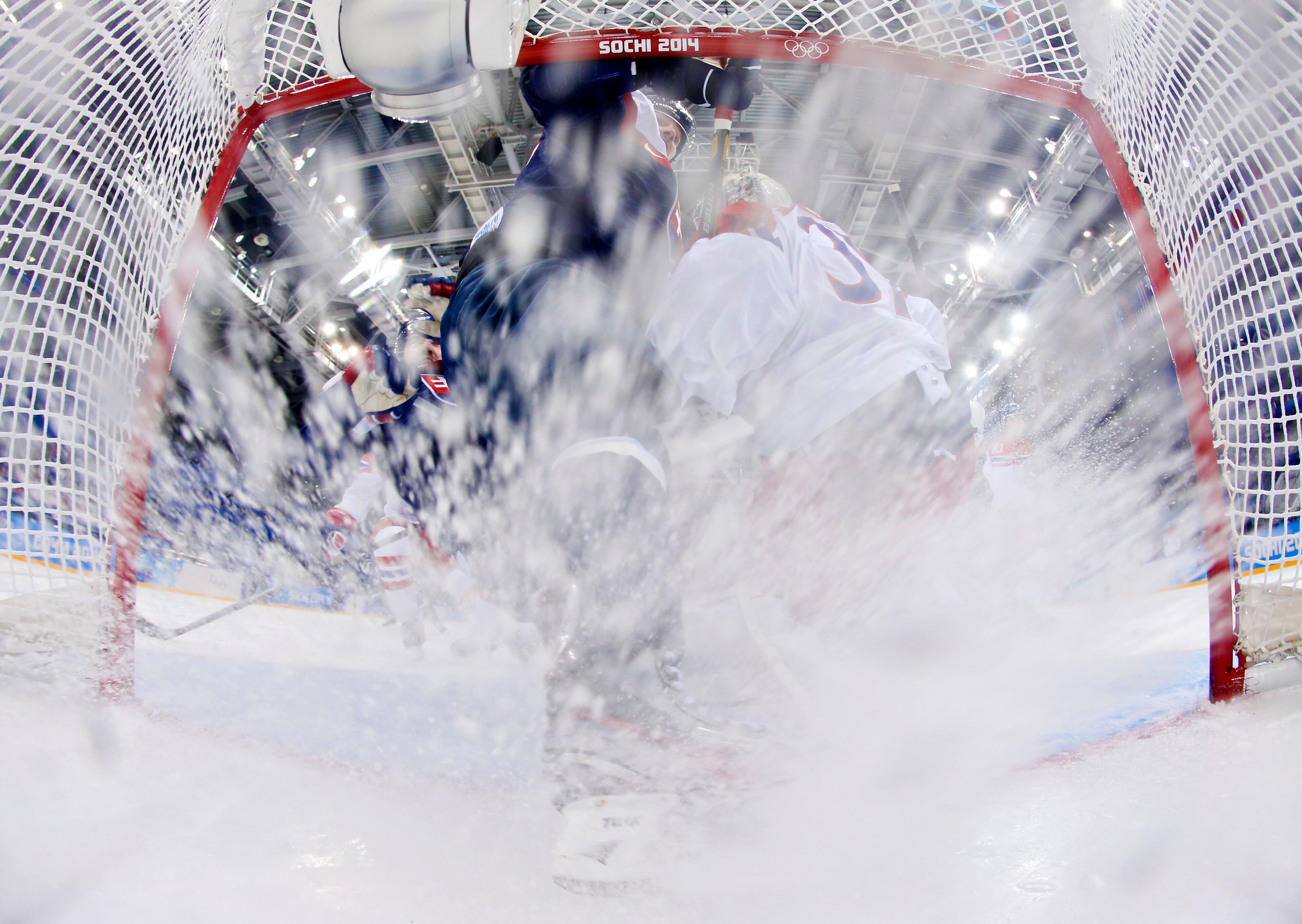 Slovakia forward Tomas Zaborsky slides into the the Czech Republic goal during the 2014 Winter Olympics men's ice hockey game at Shayba Arena, Tuesday, Feb. 18, 2014, in Sochi, Russia. The Czech Republic defeated Slovakia 5-3. (AP Photo/Martin Rose, Pool)