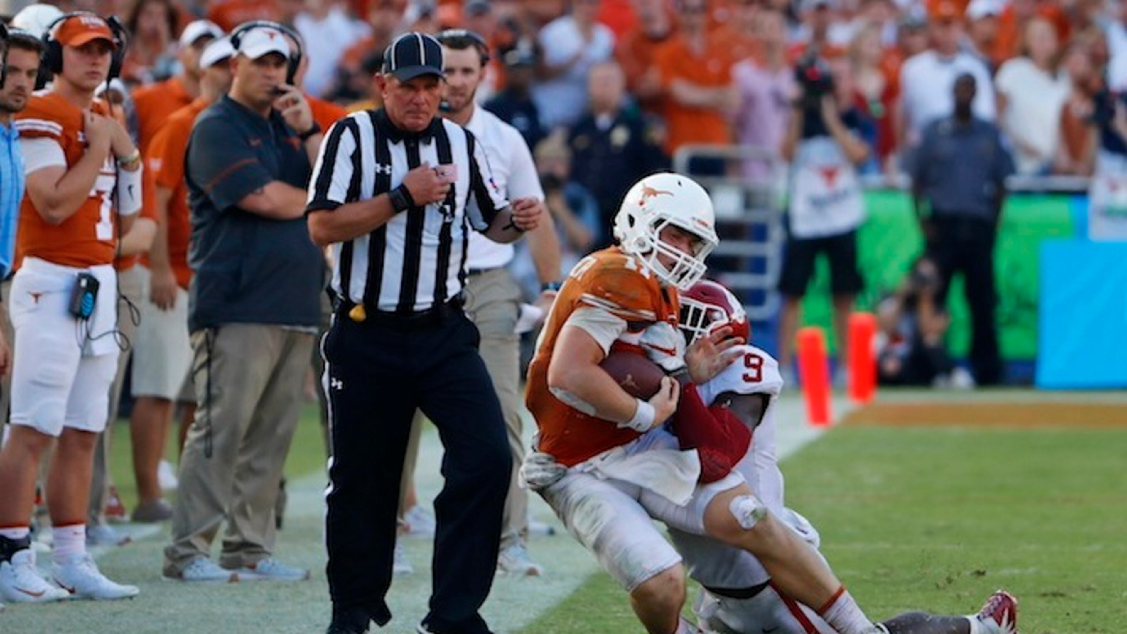 Texas quarterback Sam Ehlinger (11) is hit at the sidelines by Oklahoma linebacker Kenneth Murray (9) in the fourth quarter of the Red River Showdown at the Cotton Bowl in Dallas on October 14, 2017. (Paul Moseley/Fort Worth Star-Telegram/TNS)