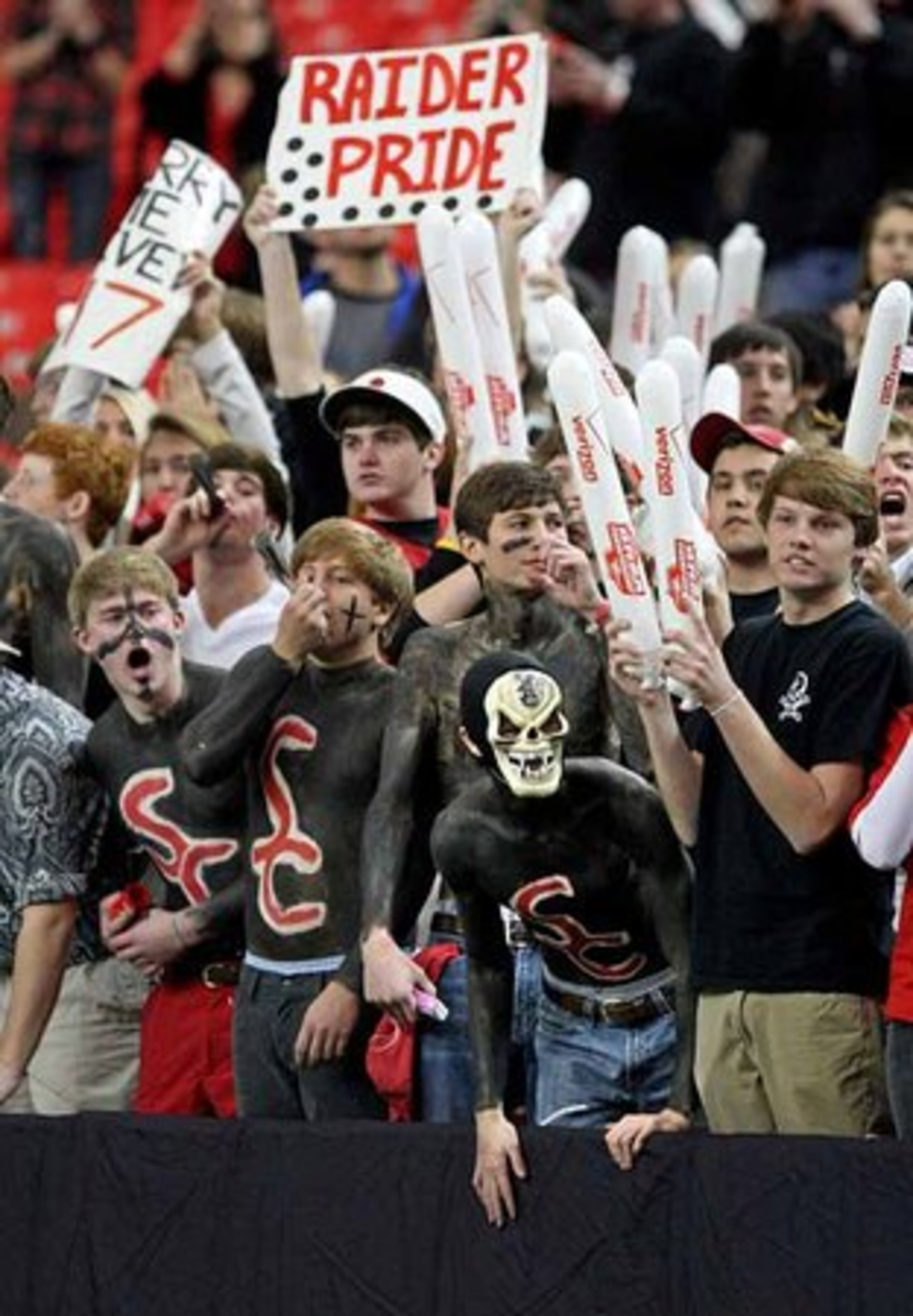 The Savannah Christian student section, including Christian Woodberry (with mask), gets fired up before their team plays Clinch County.