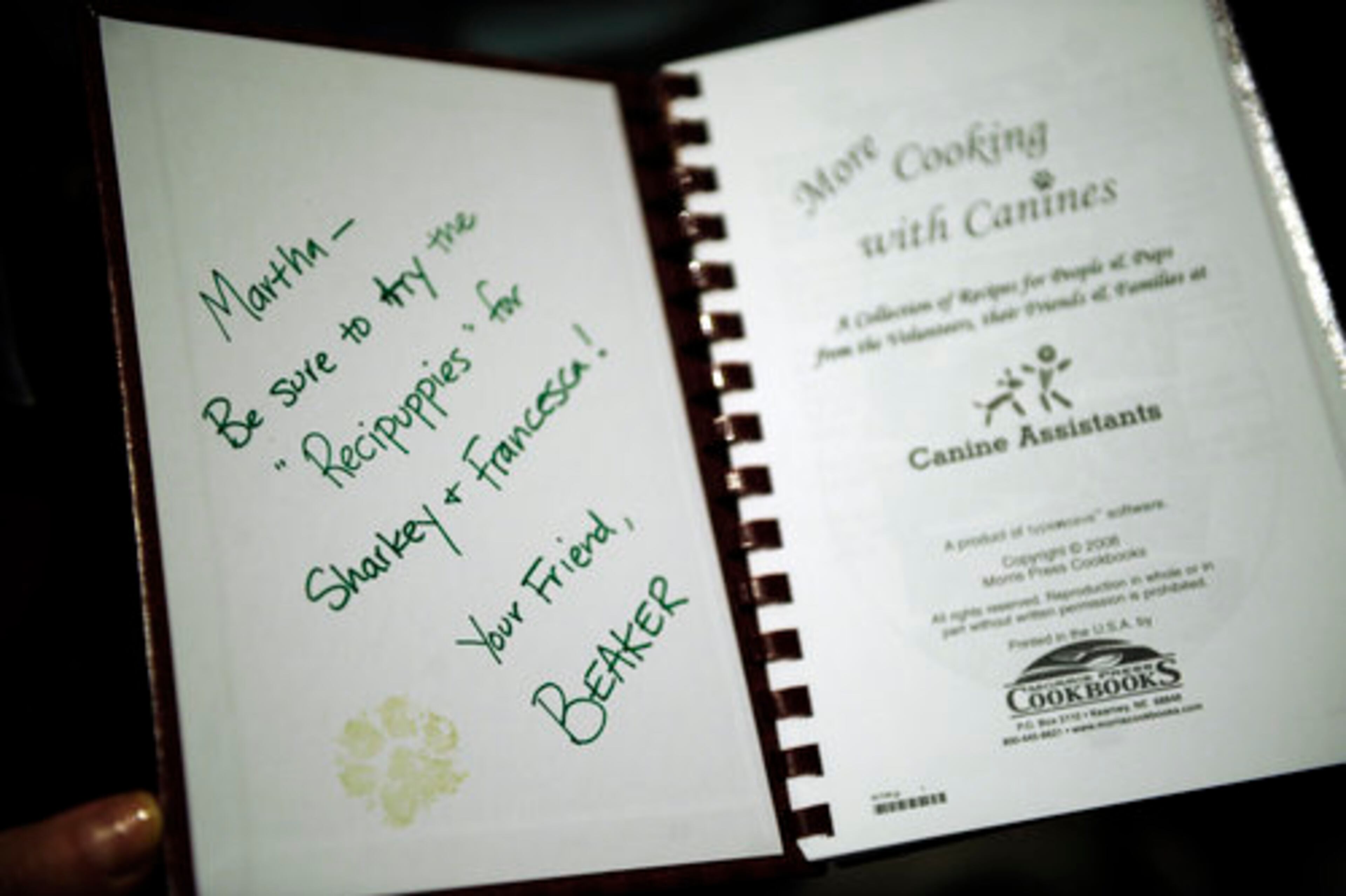 Beaker's owner, Kathy Rossi-Evanina, brought her own book, "More Cooking with Canines" to present to Stewart and raise awareness for her Alpharetta-based group, Canine Assistants.