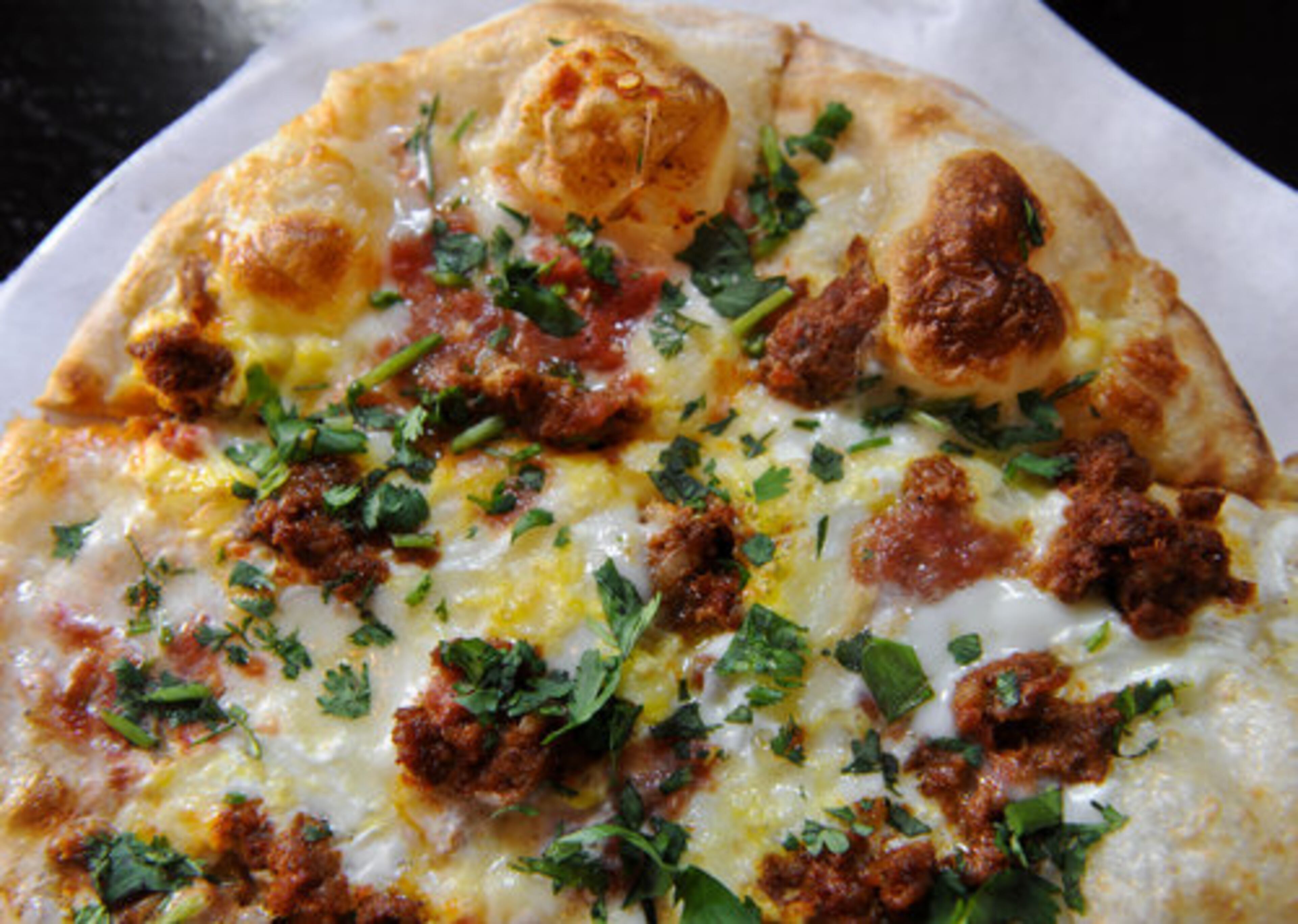 The Chorizo Sunrise Pizza -- chorizo sausage, broken yolk egg, Mexican crema, pizza cheese blend, salsa picante and chopped cilantro -- at Hearth Pizza Tavern in Sandy Springs, a spot, Jon Watson writes, that "deserves its slice of attention." Three stars.