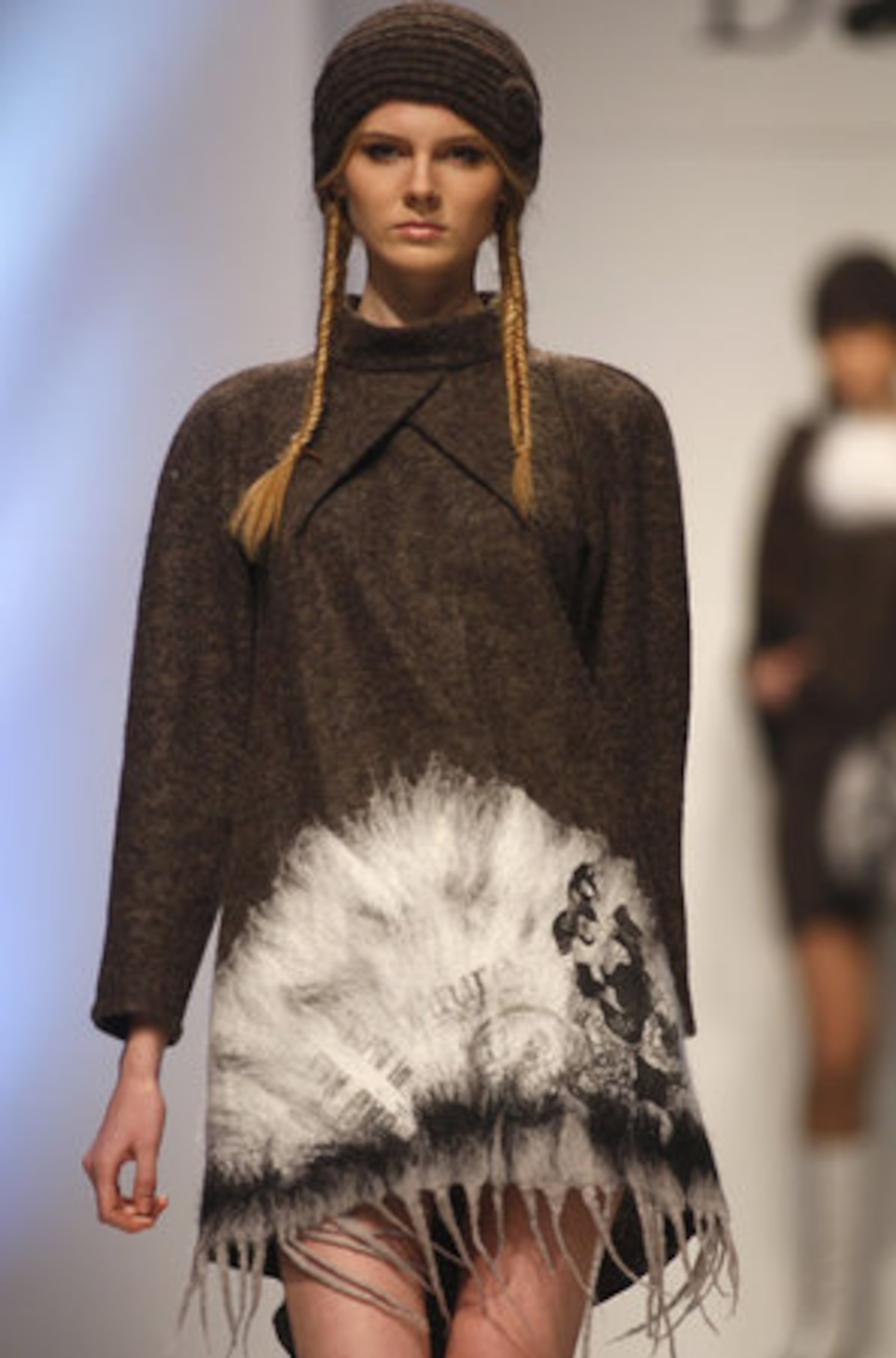 A model presents a fringed dress by Belarus designer Marina Davidova.