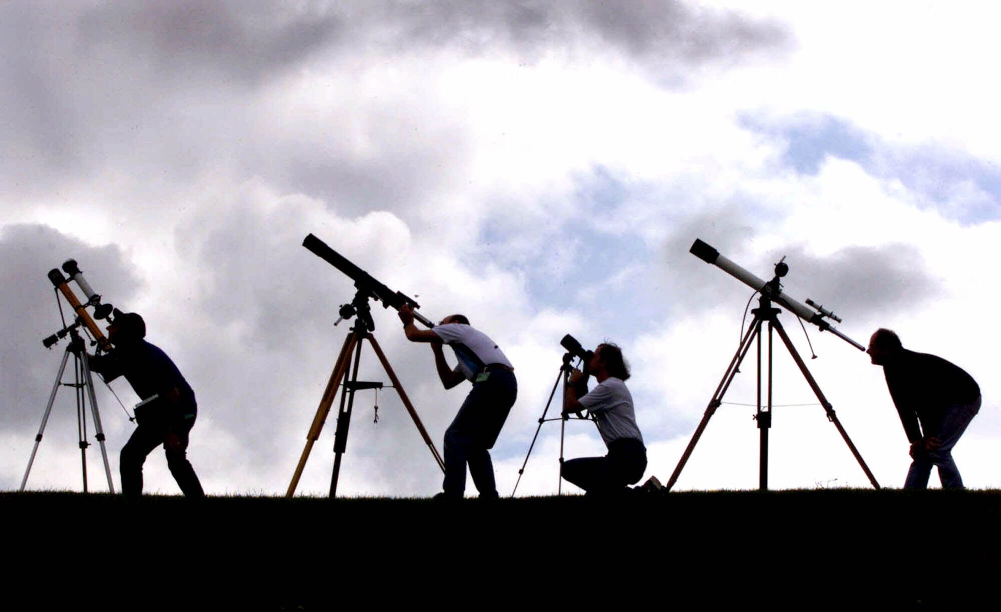 Members of the British Astronomers Association prepare their telescopes Tuesday, Aug. 10, 1999, at their campsite near Truro in Cornwall, England. The group is preparing for a total solar eclipse which will take place Wednesday. (AP Photo/Dave Caulkin)