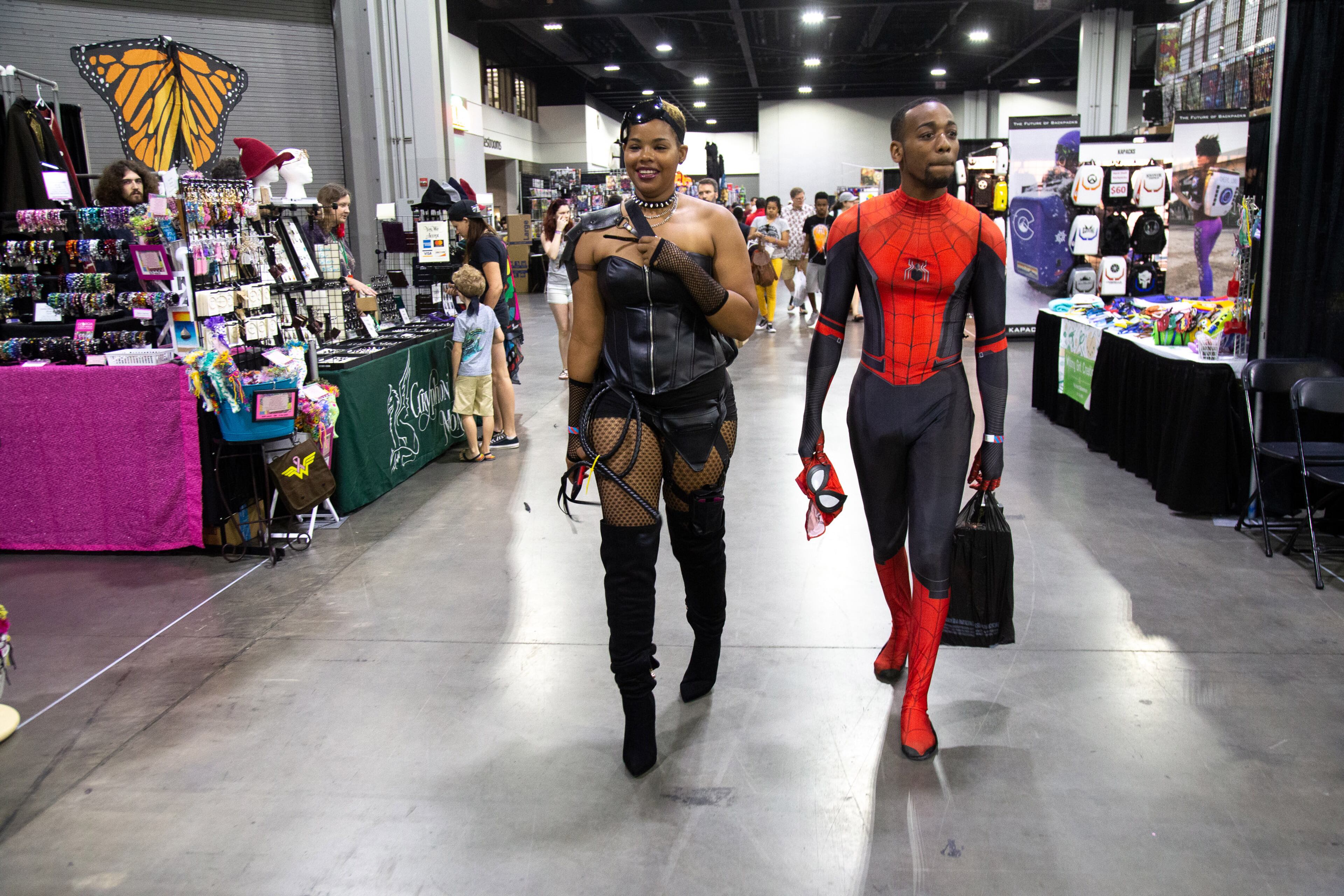 Tiffany Stodghill and Marlon Stodghill walk past the vendor booths during the Atlanta Comic Con at the Georgia World Congress Center on Sunday, July 14, 2019. STEVE SCHAEFER / SPECIAL TO THE AJC