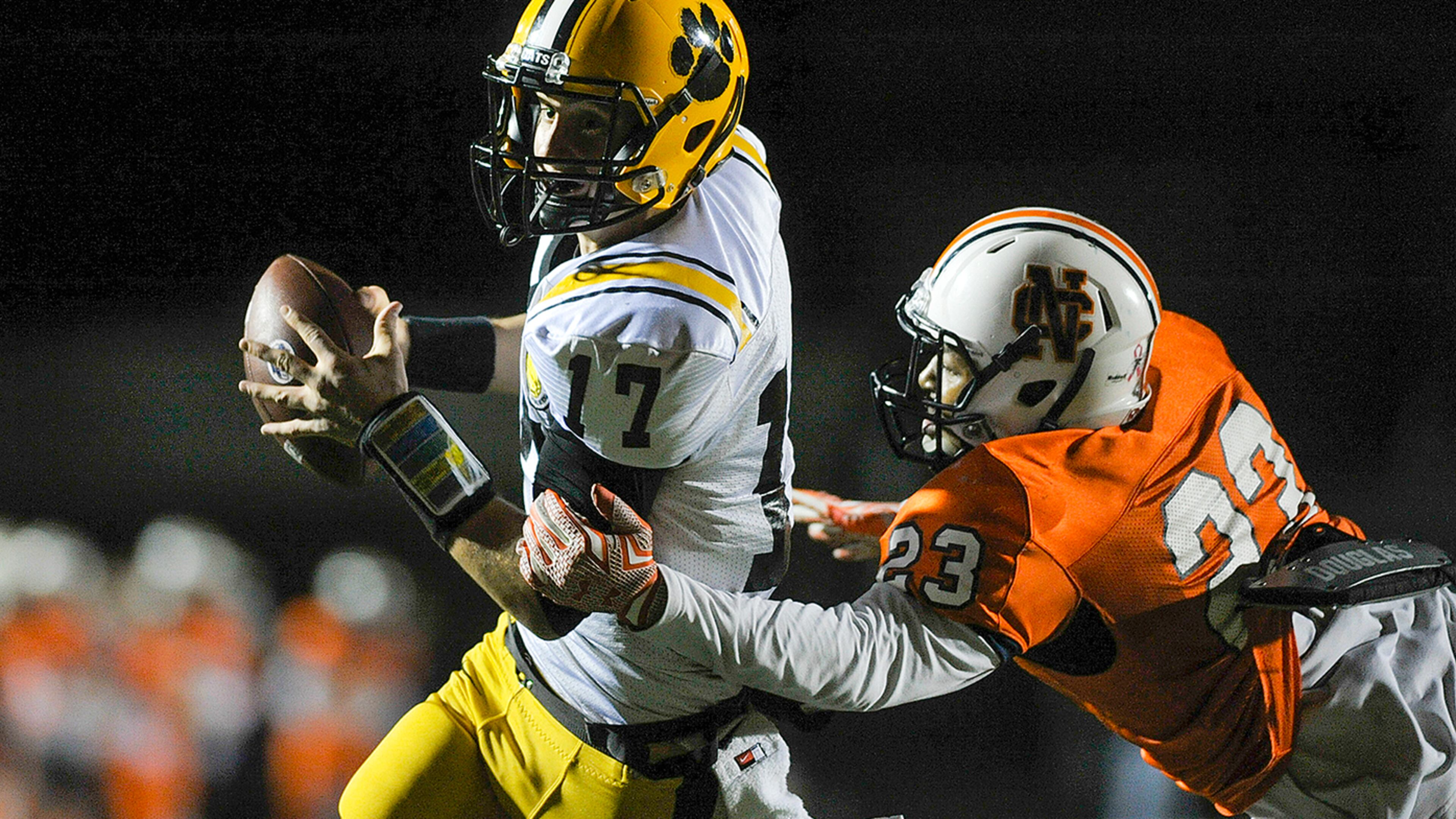 Kennesaw, Ga. -- North Cobb senior linebacker Emmanuel Pelter (23) attempts to bring down Valdosta senior QB Seth Shuman (17) in the second half of play at North Cobb in the first round of football playoffs Friday, November 13, 2015. SPECIAL/DANIEL VARNADO