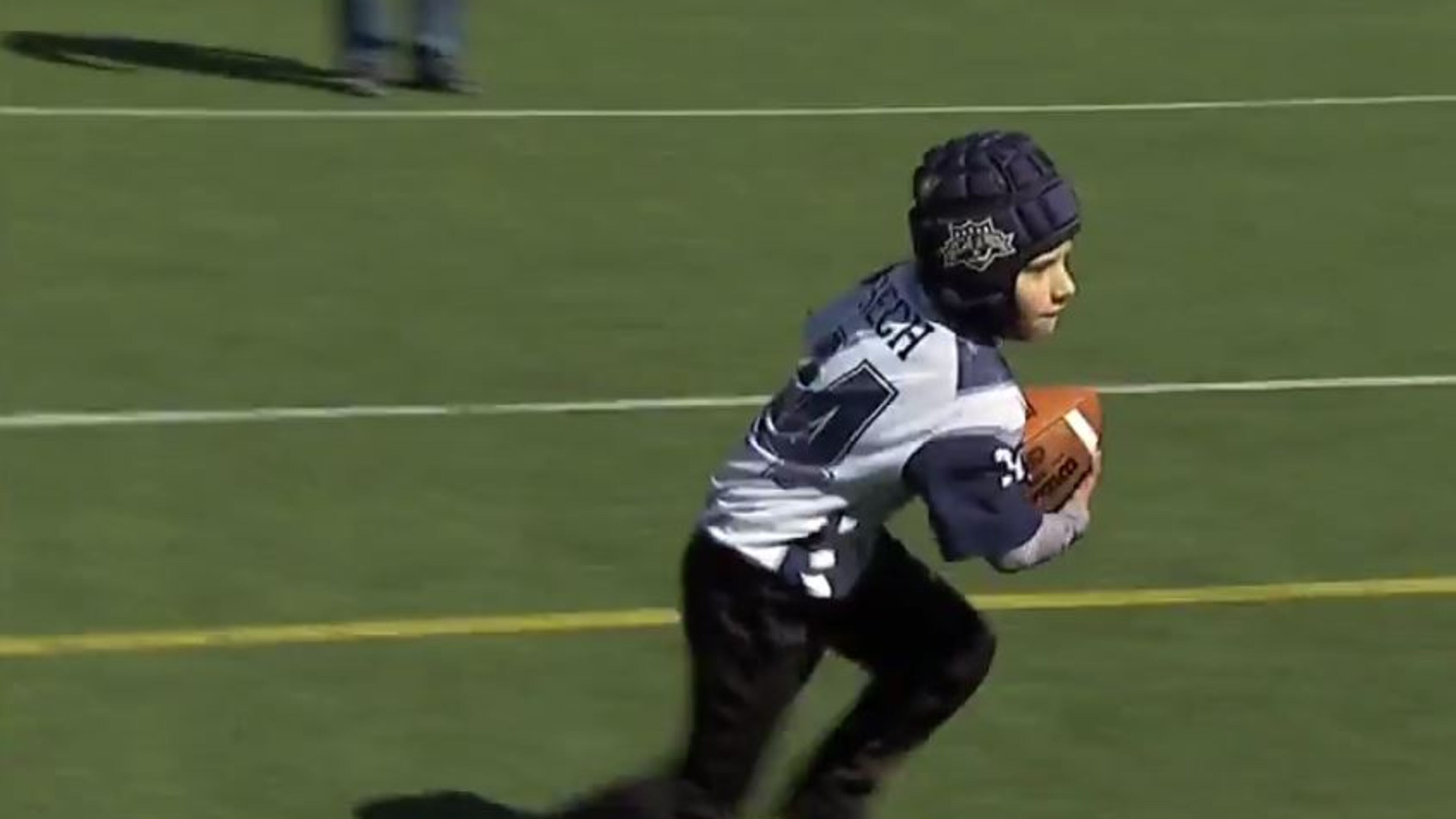 A North Atlanta Football League player tries out a soft-shell helmet.