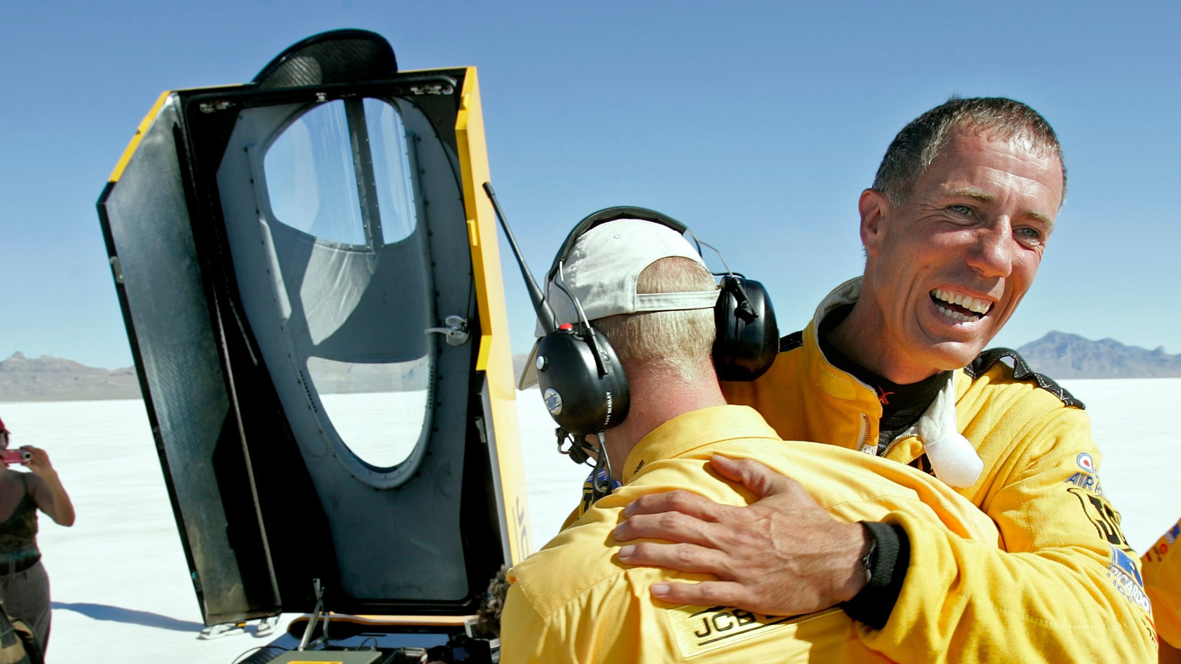 FILE - British driver Andy Green, right, is congratulated by a crew member after setting a new unofficial world diesel powered land speed record of over 328 mph over two runs on the Bonneville Salt Flats in Utah on Tuesday, Aug. 2006. (AP Photo/Douglas C. Pizac, File)