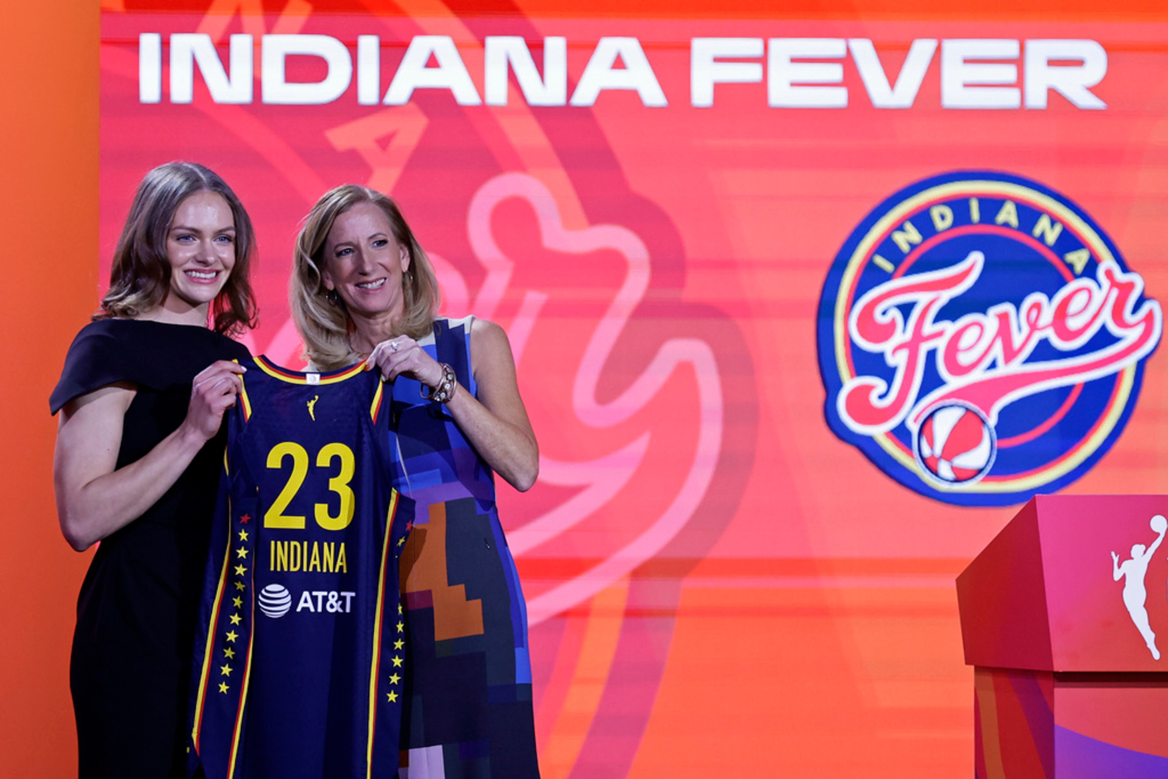Indiana's Grace Berger, left, poses for a photo with commissioner Cathy Engelbert after being selected by the Indiana Fever at the WNBA basketball draft Monday, April 10, 2023, in New York. (AP Photo/Adam Hunger)