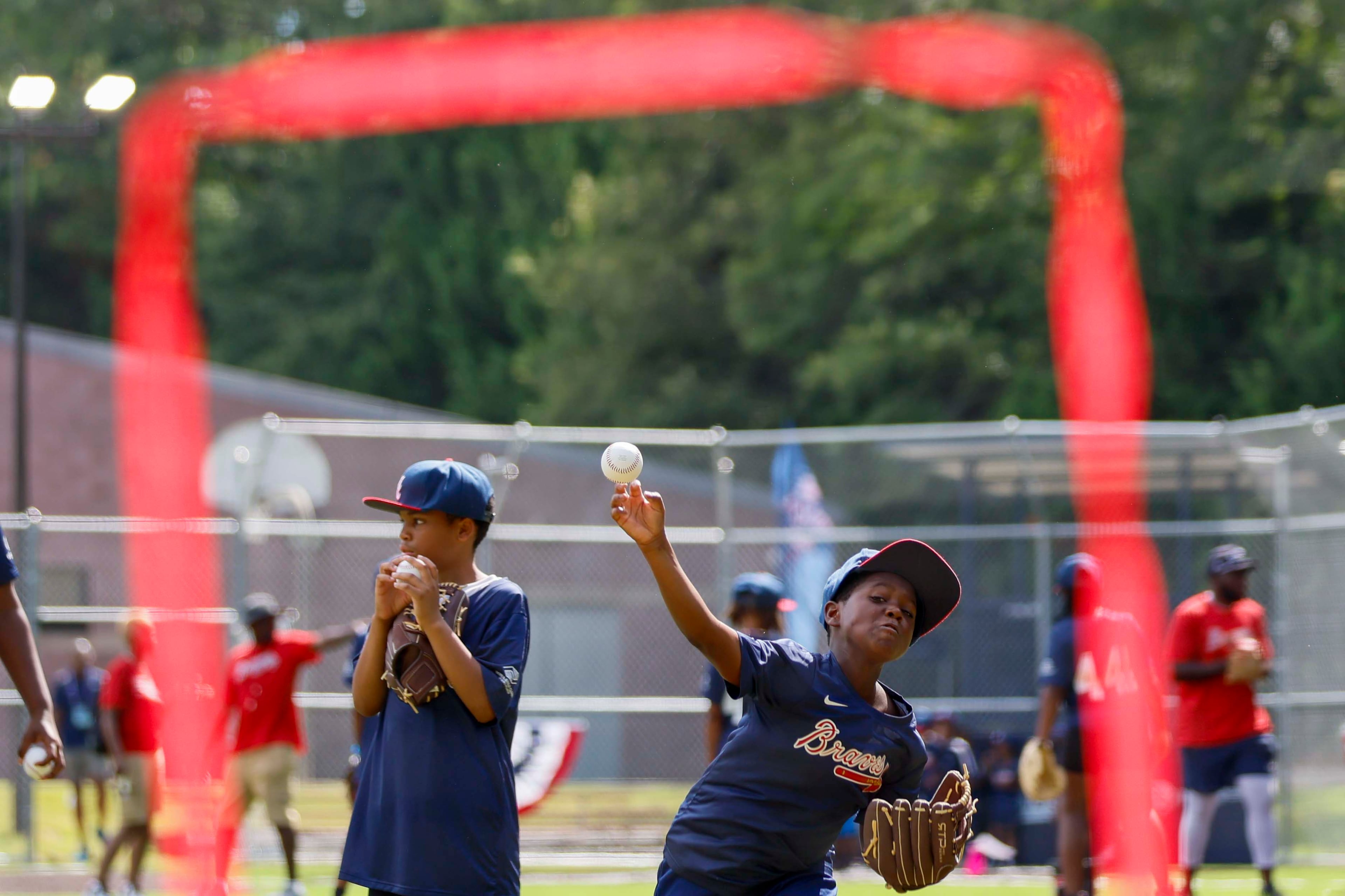 A kid is seen throwing a pitch as he participates in a drill during the unveiling of the new All-Star Legacy Field at the Barksdale Boys & Girls Club in Conyers on Thursday, July 10, 2025. The event takes place during the MLB All-Star Game week in Atlanta.
(Miguel Martinez/ AJC)