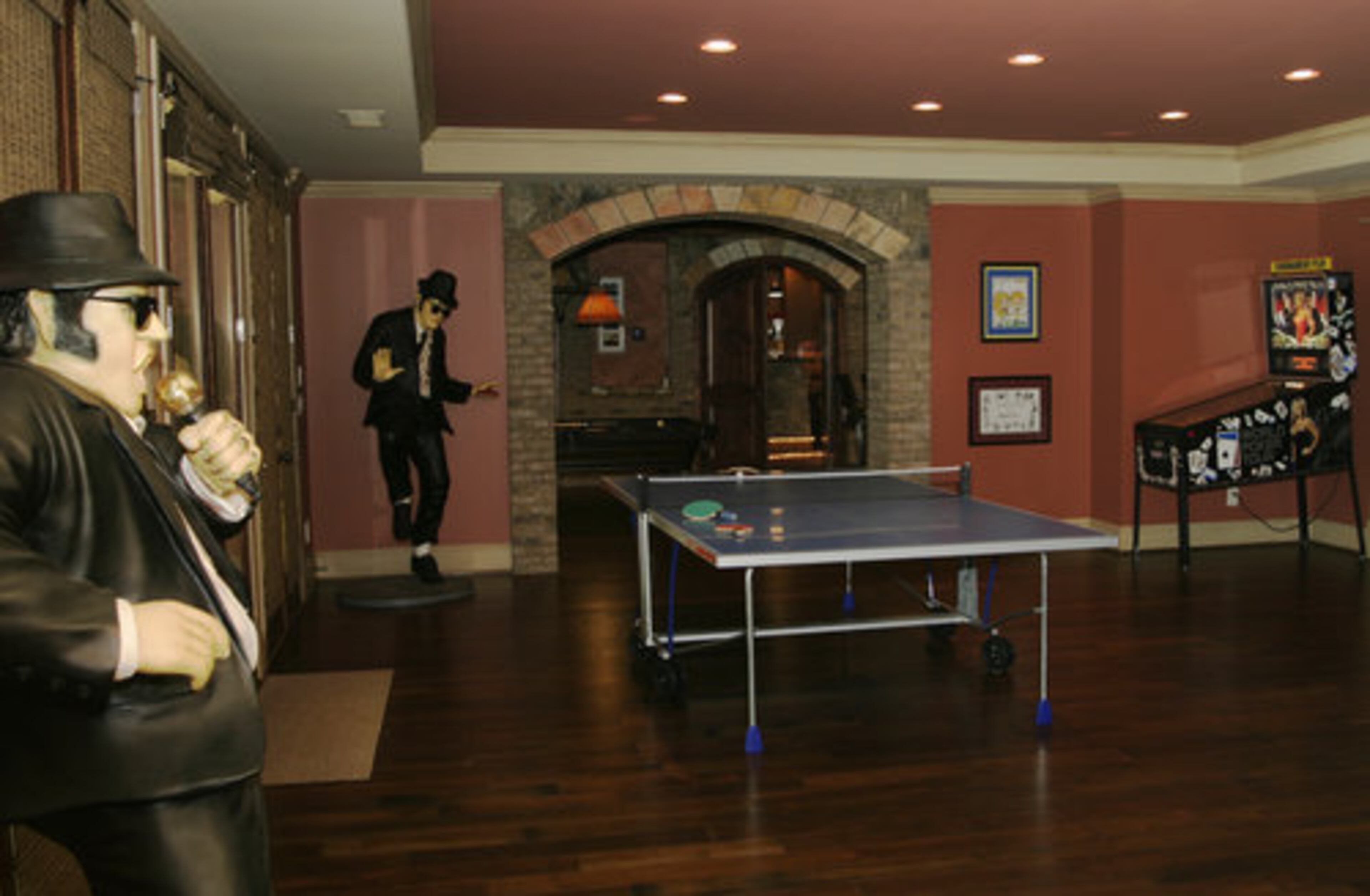 The lower level is the recreation zone, which has a center room with a ping-pong table and two arcade games.