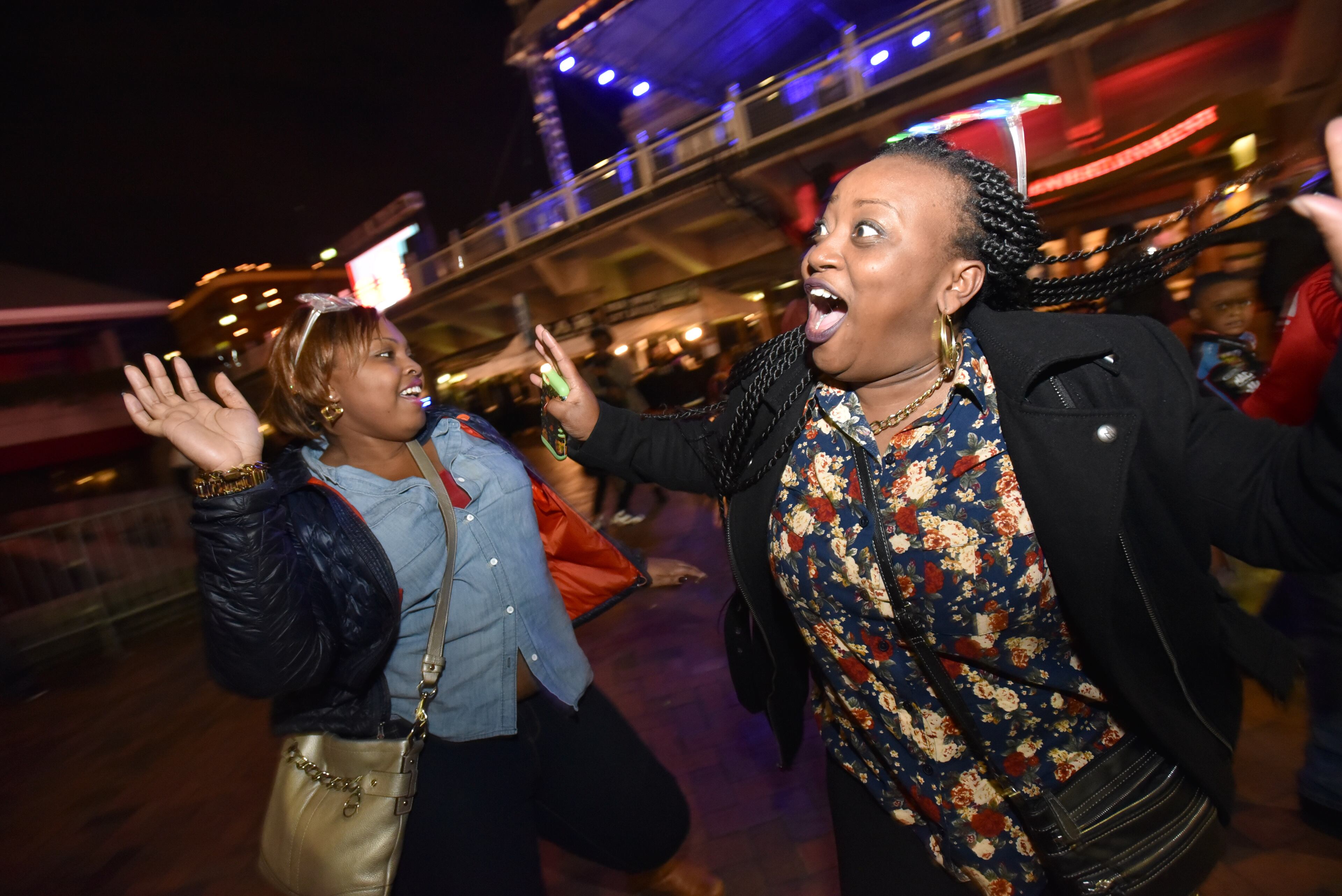 Kassy Foster (left) and Shavoka Kimes, both from Mississippi, dance to the live music at Underground Atlanta at the Peach Drop 2016 on Thursday, December 31, 2015. Peach Drop, the largest New Year's Eve celebration in the Southeast, continues a 27-year tradition in Downtown Atlanta with an evening of entertainments. Festivities continue well into the New Year with a variety of live performances, followed by the descent of the 800-pound Peach and a firework display.