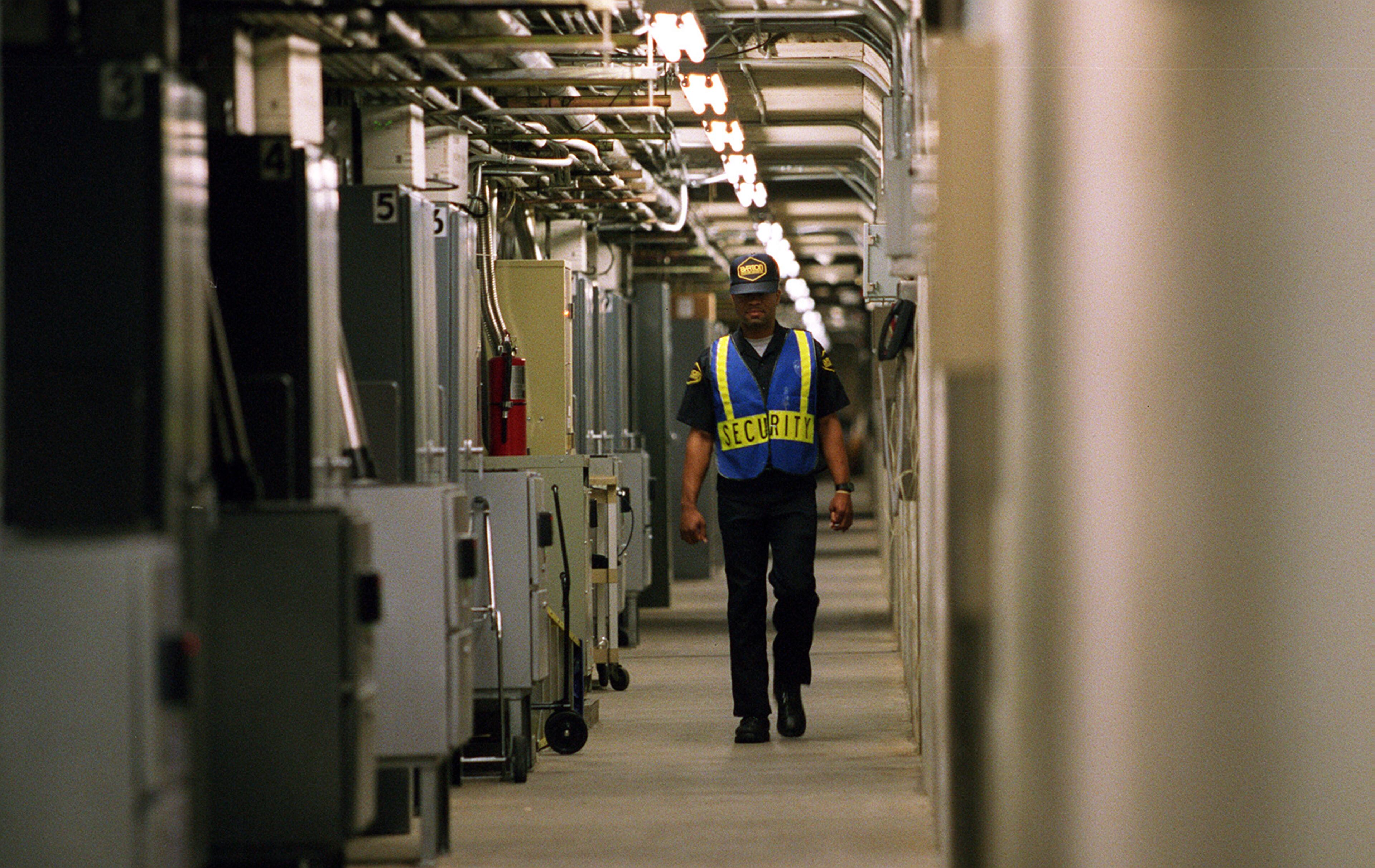 The Georgia 400 toll way has it's own version of the catacombs where all the monies descend after being deposited above by the passing cars through the booths. Here security guard J. Travis of Barton Protective Services keeps an eye on things in the tunnel that spans across both ways of 400 on April 24, 1997. (AJC Staff Photo/John Spink)