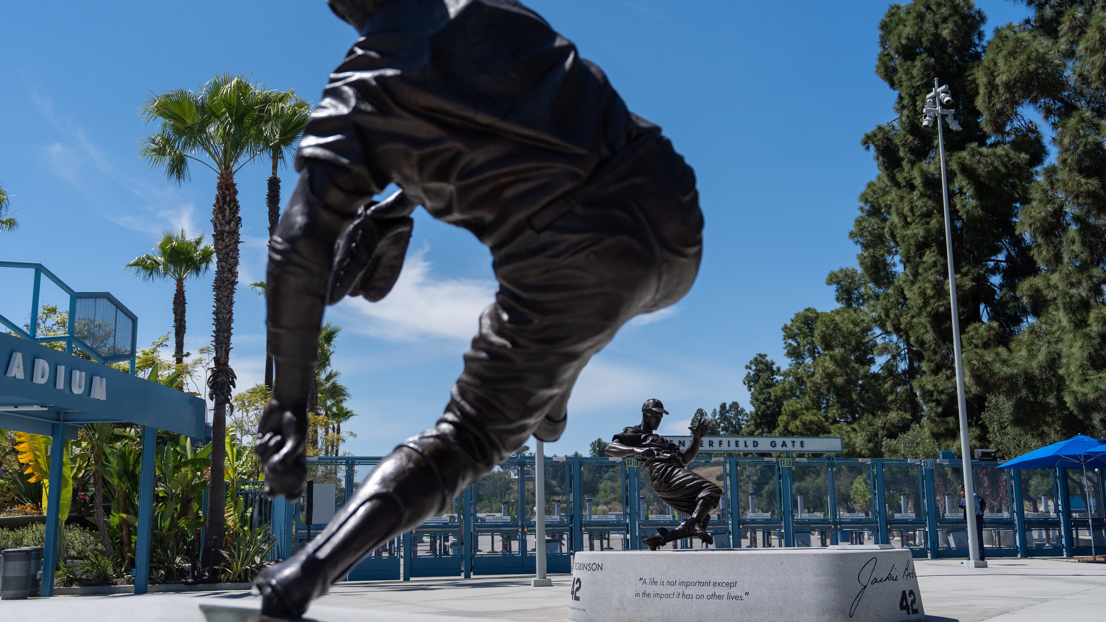 Statues of Sandy Koufax, foreground, and Jackie Robinson stand outside Dodger Stadium before a baseball game between the Los Angeles Dodgers and the New York Mets, Wednesday, April 15, 2026, in Los Angeles. (AP Photo/Jae C. Hong)