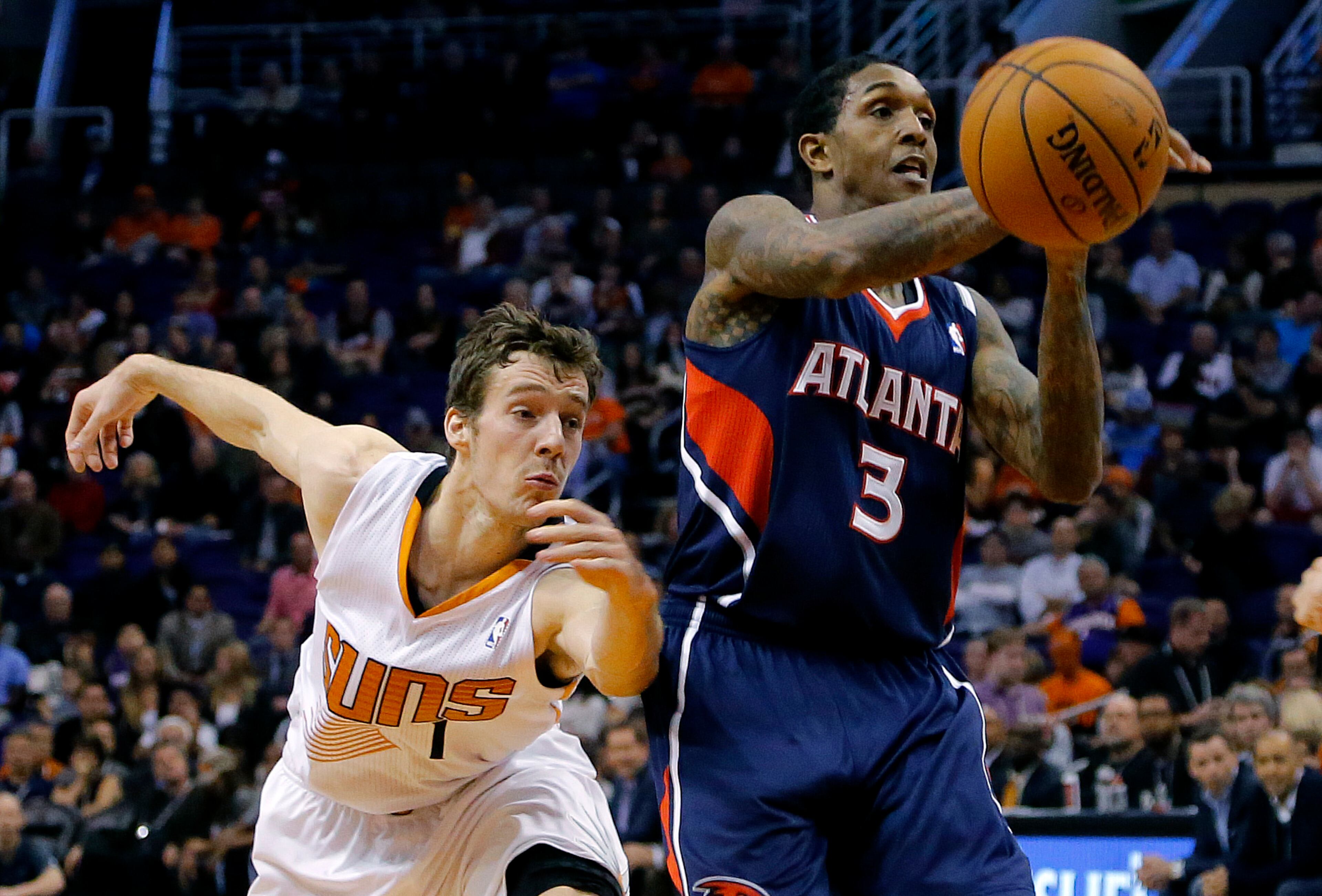 Atlanta Hawks' Louis Williams (3) loses the ball as Phoenix Suns' Goran Dragic, of Slovenia, reaches in during the first half of an NBA basketball game, Sunday, March 2, 2014, in Phoenix. (AP Photo/Matt York)