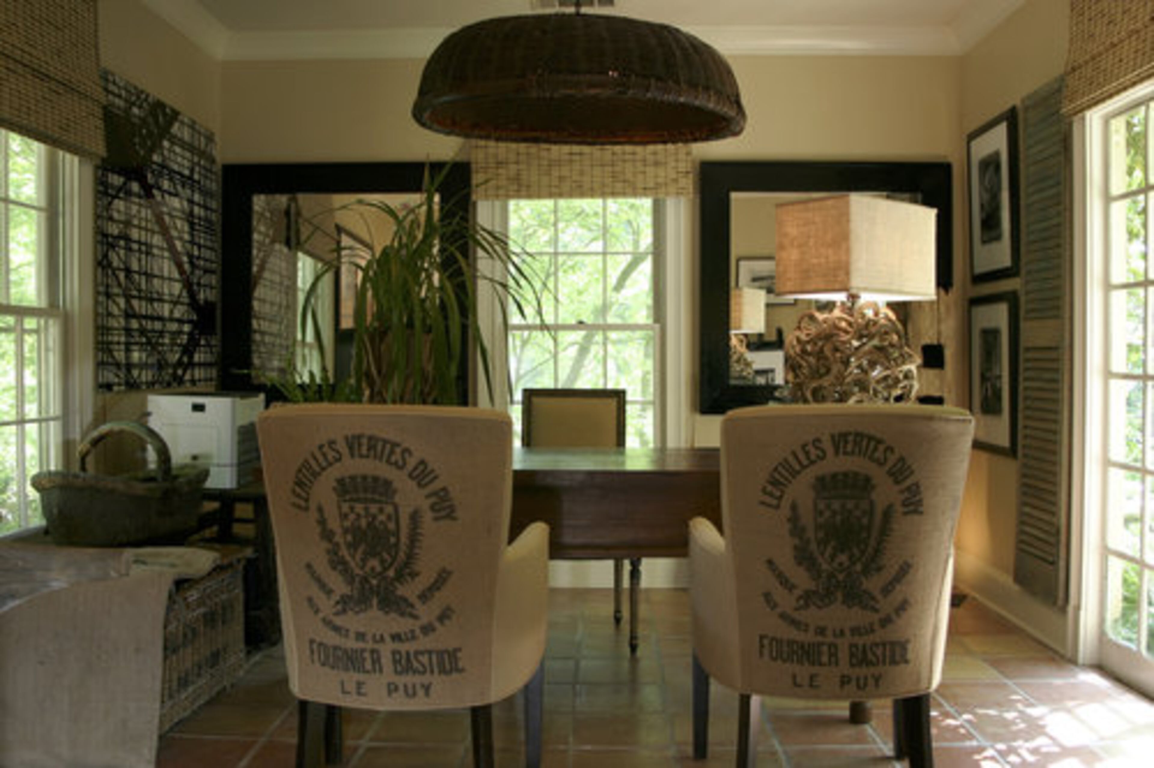 Mary Bairstow's design style is distinguished by her use of novel and rare items such as lentil grain sacks which she restructures into pillows and uses on chairs, as illustrated in her home-office. She applied a natural fine linen on the seats of these chairs.