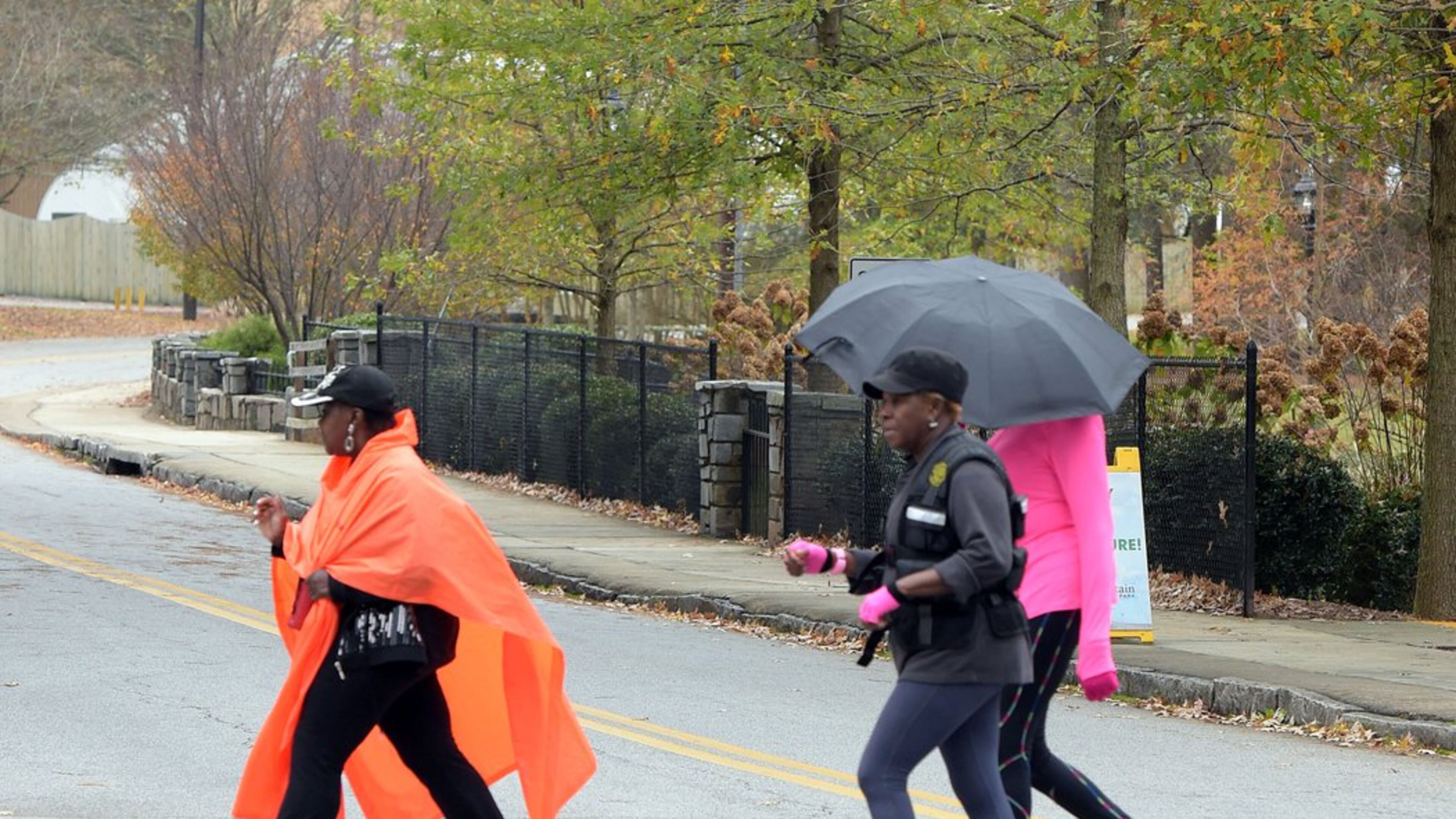 People exercise under gray skies Thursday at Stone Mountain Park. A large proportion of the park’s visitors are African-American, despite the park’s Confederate themes. KENT D. JOHNSON/KDJOHNSON@AJC.COM