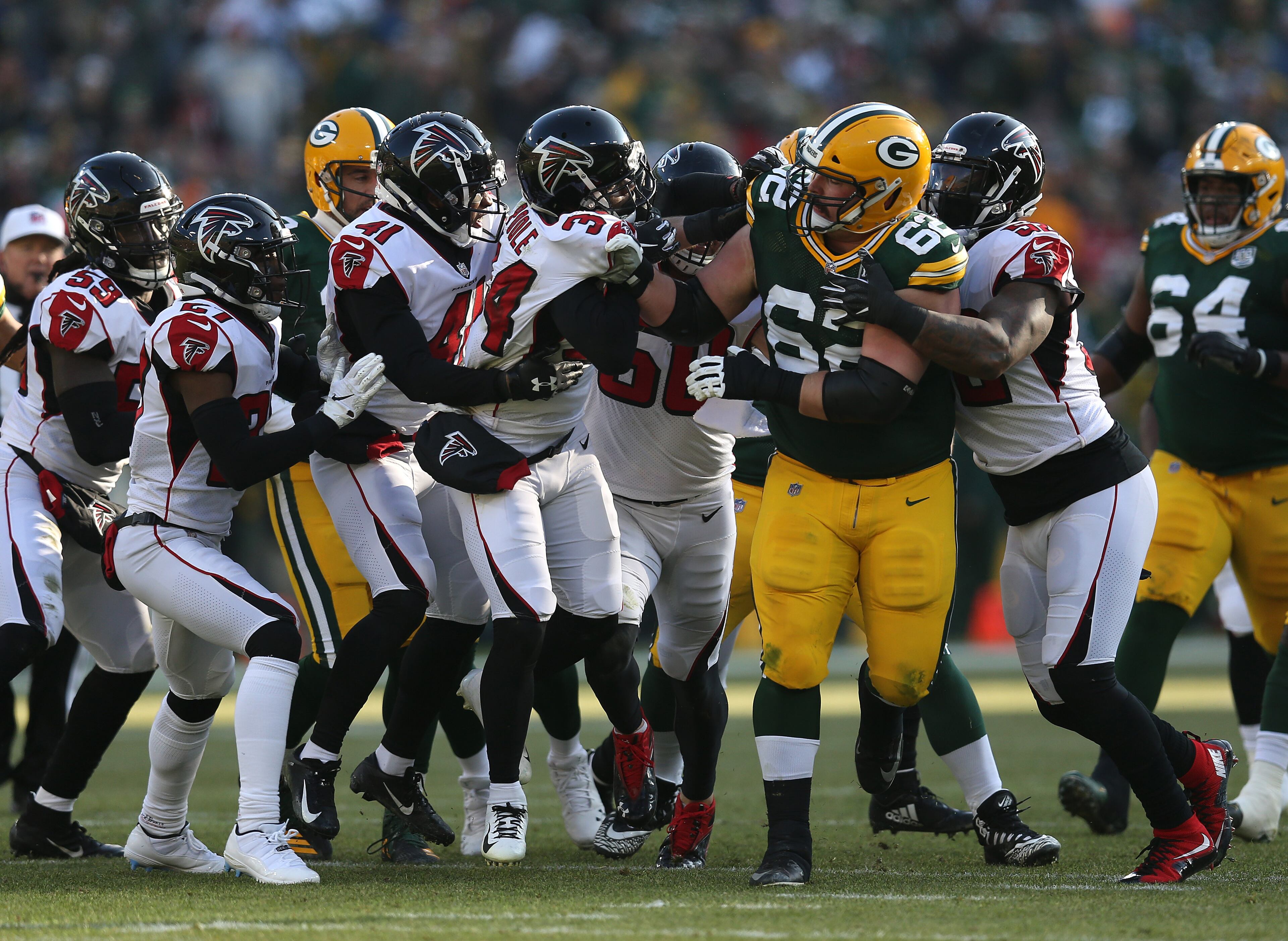 GREEN BAY, WISCONSIN - DECEMBER 09: Lucas Patrick #62 of the Green Bay Packers fights with members of the Atlanta Falcons defense during the first half of a game at Lambeau Field on December 09, 2018 in Green Bay, Wisconsin. (Photo by Dylan Buell/Getty Images)
