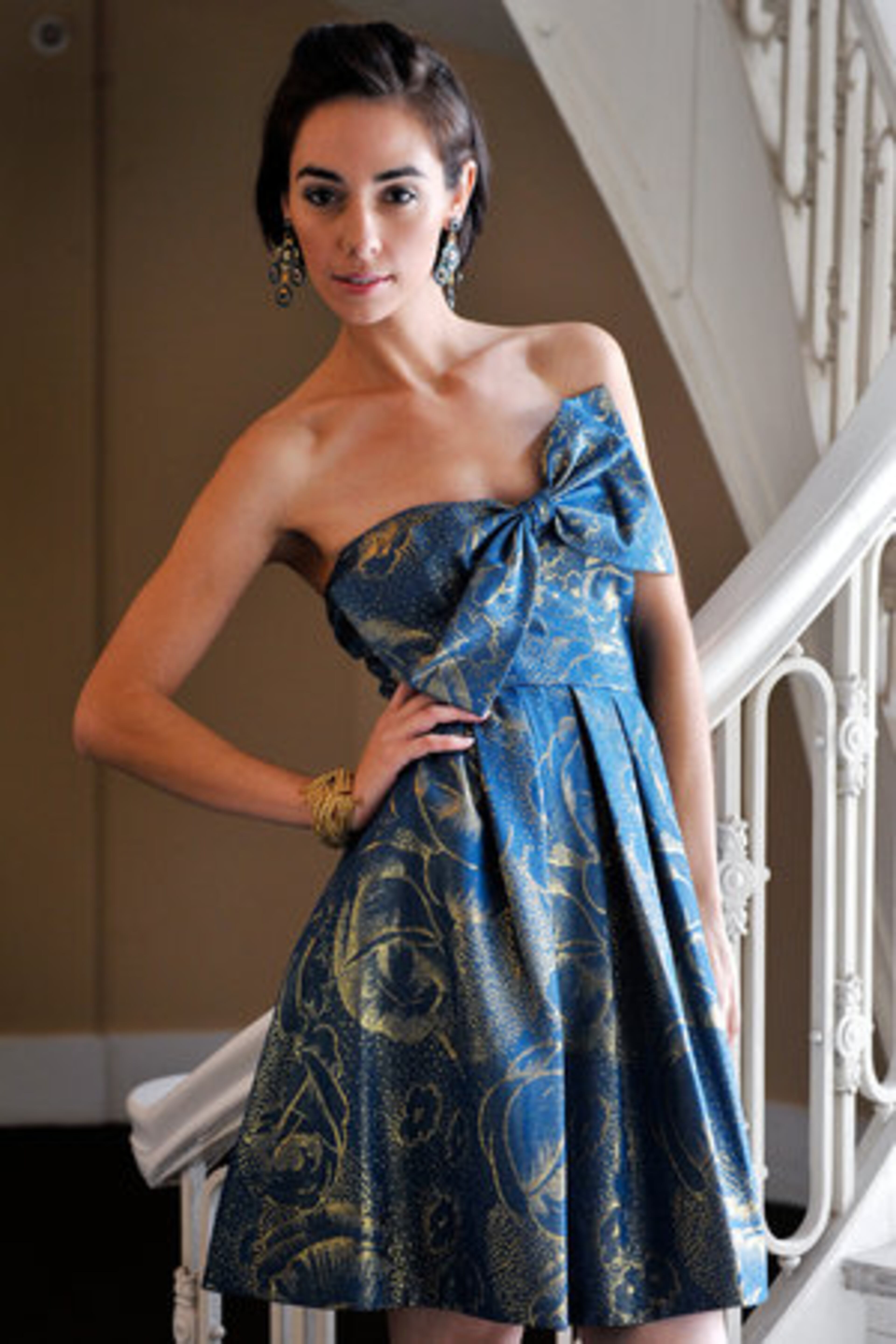 A bow takes a bow on this metallic party dress in a standout color. Dress: Rebecca Taylor, $356 at Sandpiper boutiques. Earrings: Miguel Ases, $350 at Etc. East. Bracelet: Beaded and braided gold bangle by Rosena Sammi, $100 at Etc. East. Photographed at the Georgian Terrace Hotel in Atlanta.