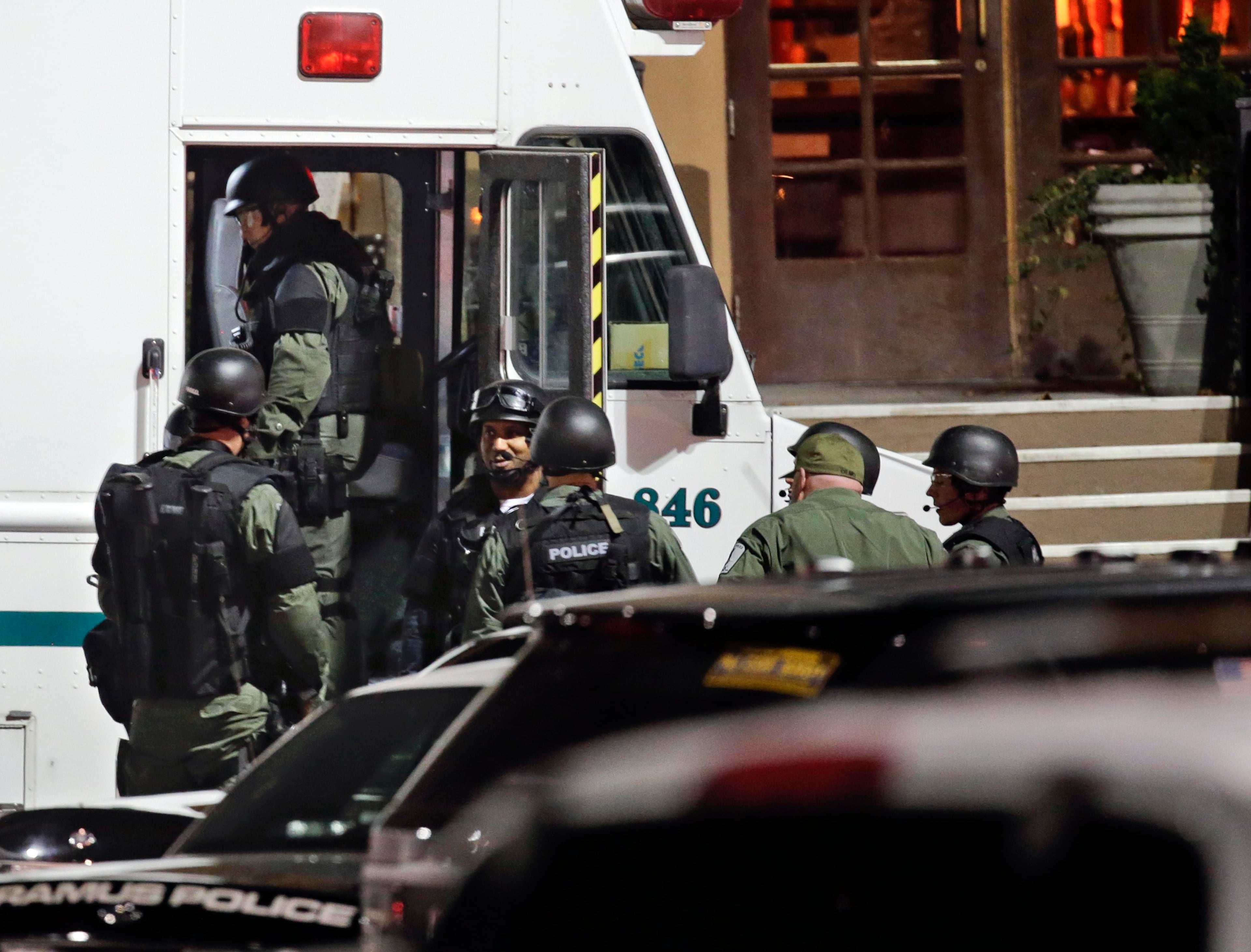 Heavily armed police wear flack jackets and helmets as they prepare to search the Garden State Plaza mall in response to reports that a gunman had fired shots in the mall, in Paramus, New Jersey November 5, 2013. A person with a gun opened fire on Monday evening in the massive New Jersey shopping mall shortly before closing time, leading police to evacuate the mall and search for the shooter, but no injuries were reported, officials said. REUTERS/Ray Stubblebine