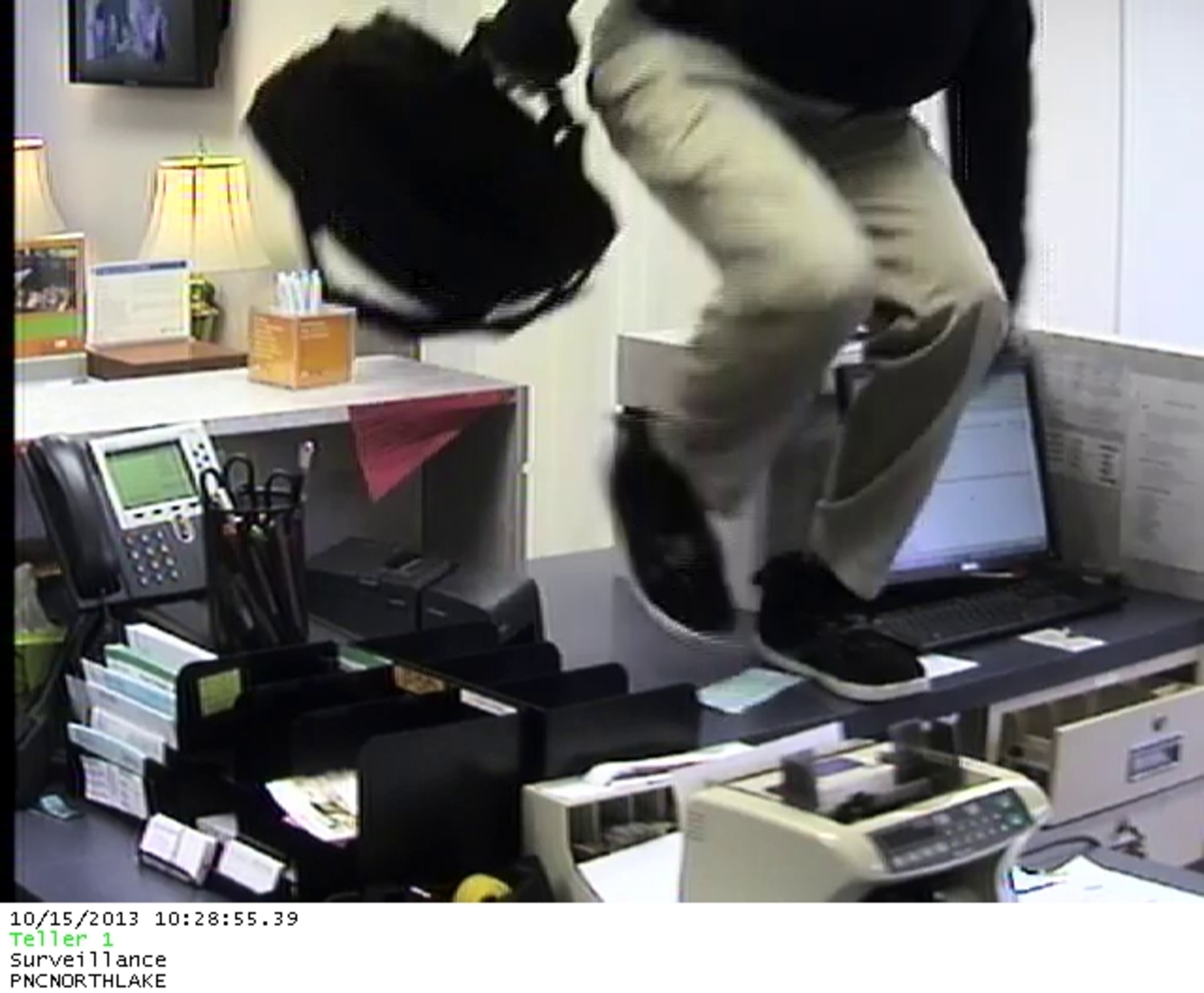 The robber was wearing a black shirt, khaki or tan pants, a brown hat and sunglasses. He appeared to have a pillow or padding stuffed in his shirt and possibly something stuffed in his jaw or cheeks.