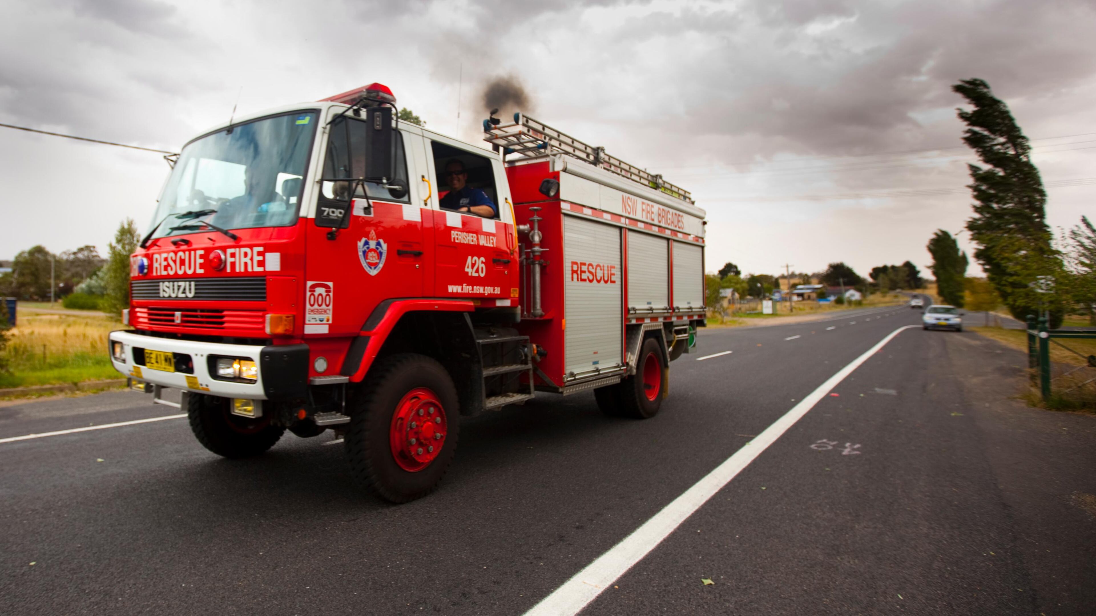 Two boys were injured when they were hit by a car as they ran to see Santa Claus on a fire truck, authorities said.