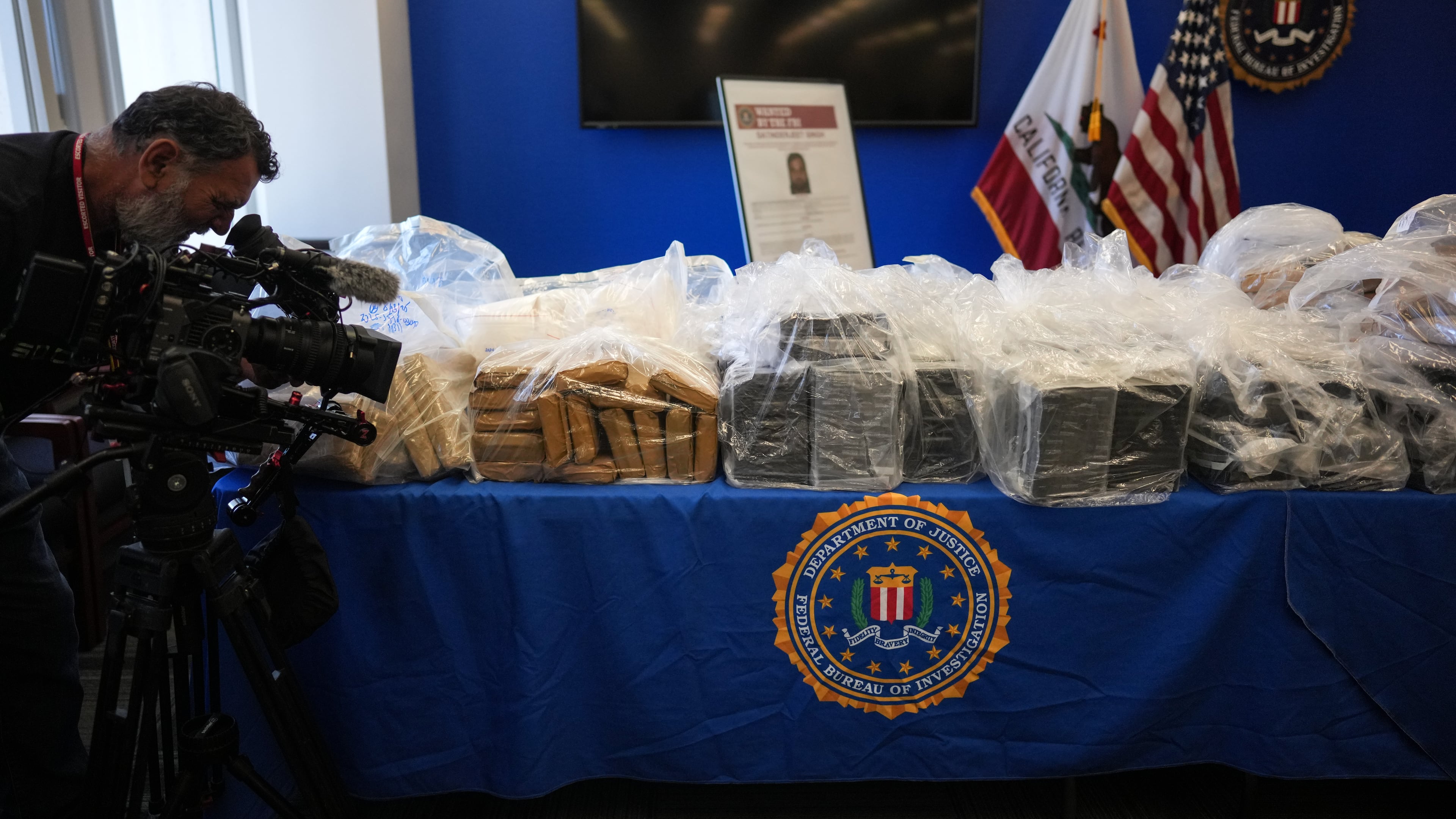 A cameraman records seized evidence at a news conference at the Federal Building in Los Angeles, Tuesday, July 7, 2026. (AP Photo/Jae C. Hong)