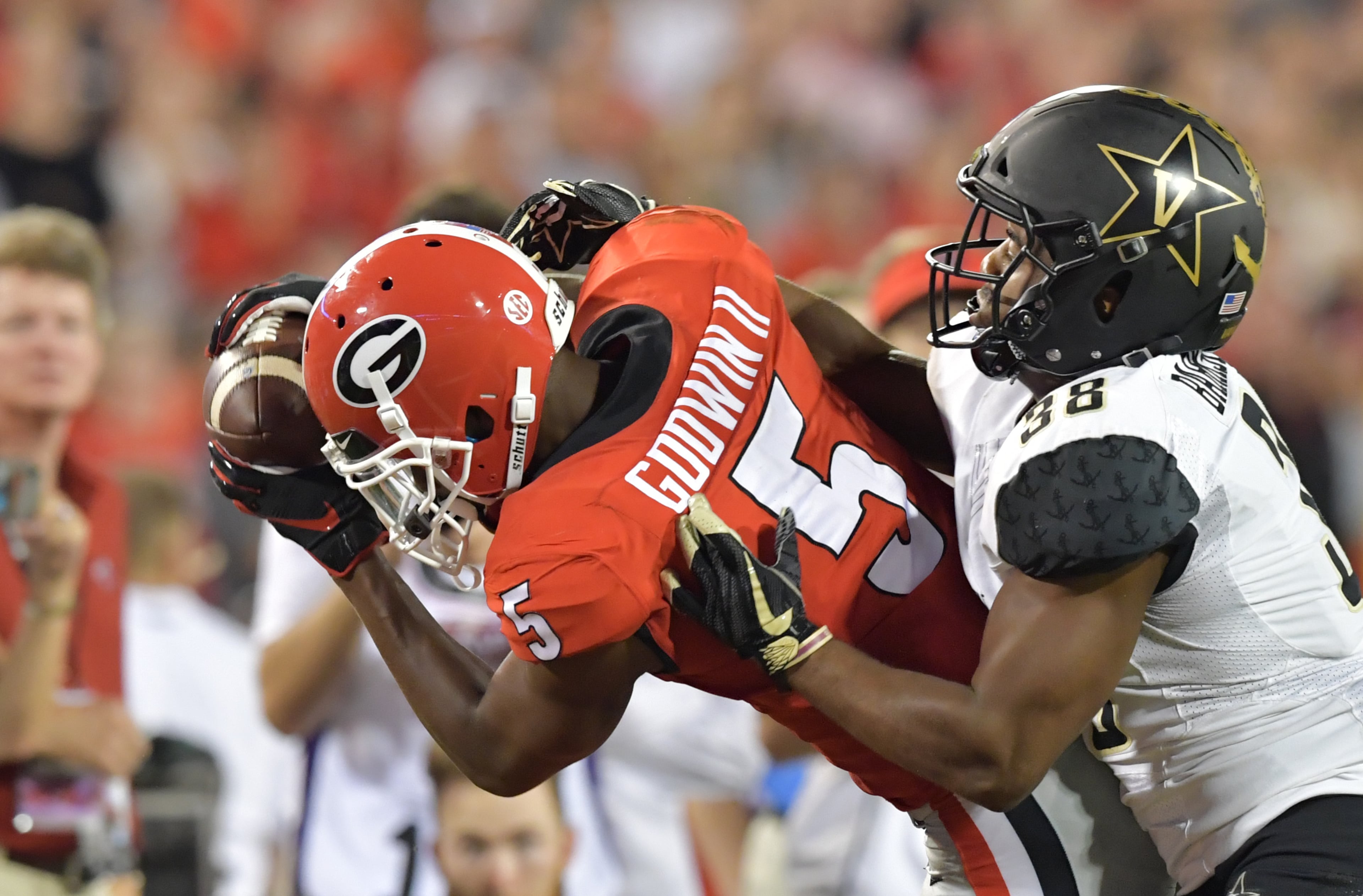 October 6, 2018 Athens - Georgia wide receiver Terry Godwin (5) makes a catch under pressure from Vanderbilt defensive back Gil Barksdale (38) in the second half during a NCAA college football game at Sanford Stadium in Athens on Saturday, October 6, 2018. Georgia won 41-13 over the Vanderbilt. HYOSUB SHIN / HSHIN@AJC.COM