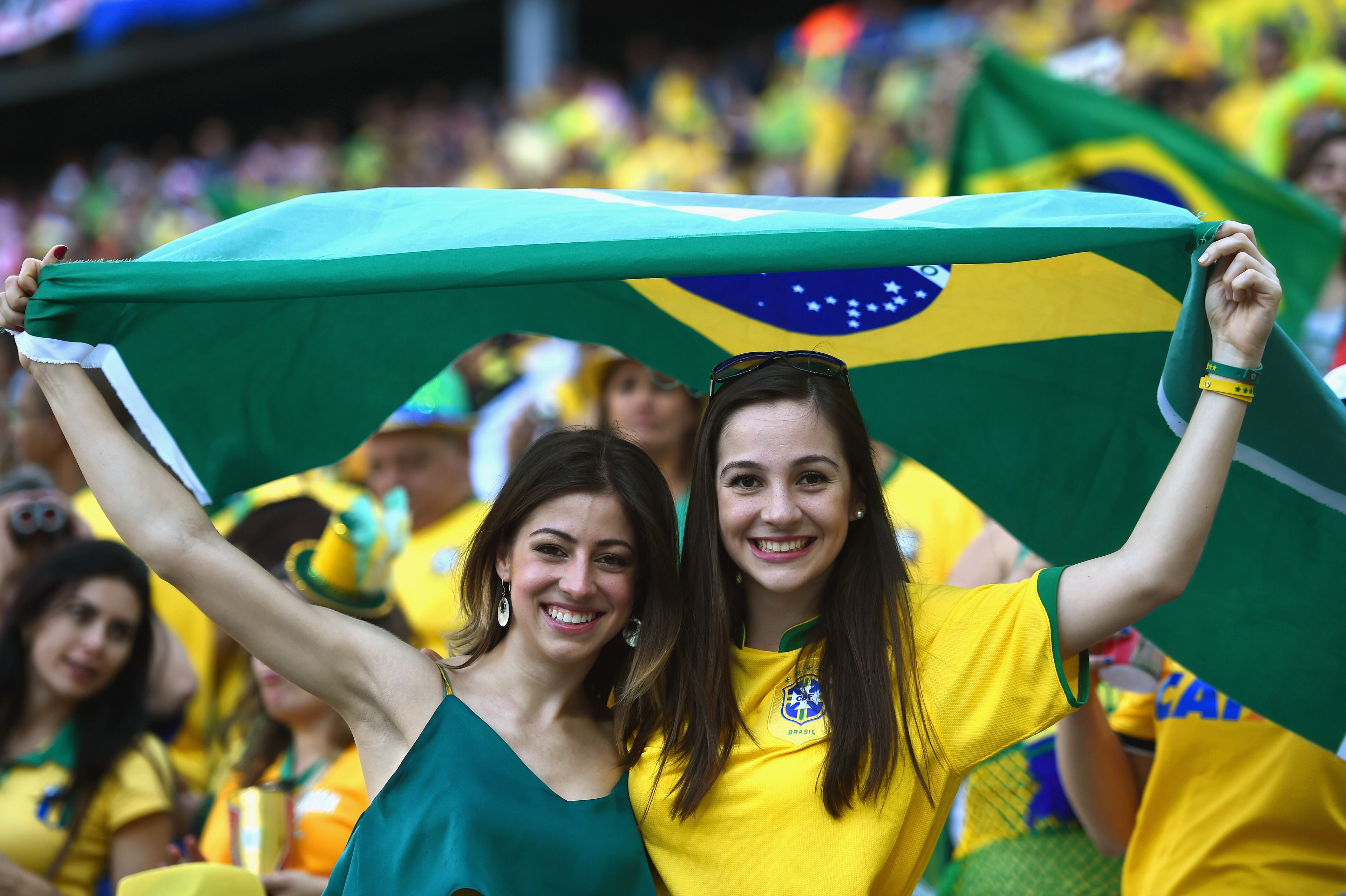 SAO PAULO, BRAZIL - JUNE 12: Fans wave a Brazilian flag before the 2014 FIFA World Cup Brazil Group A match between Brazil and Croatia at Arena de Sao Paulo on June 12, 2014 in Sao Paulo, Brazil. (Photo by Christopher Lee/Getty Images)