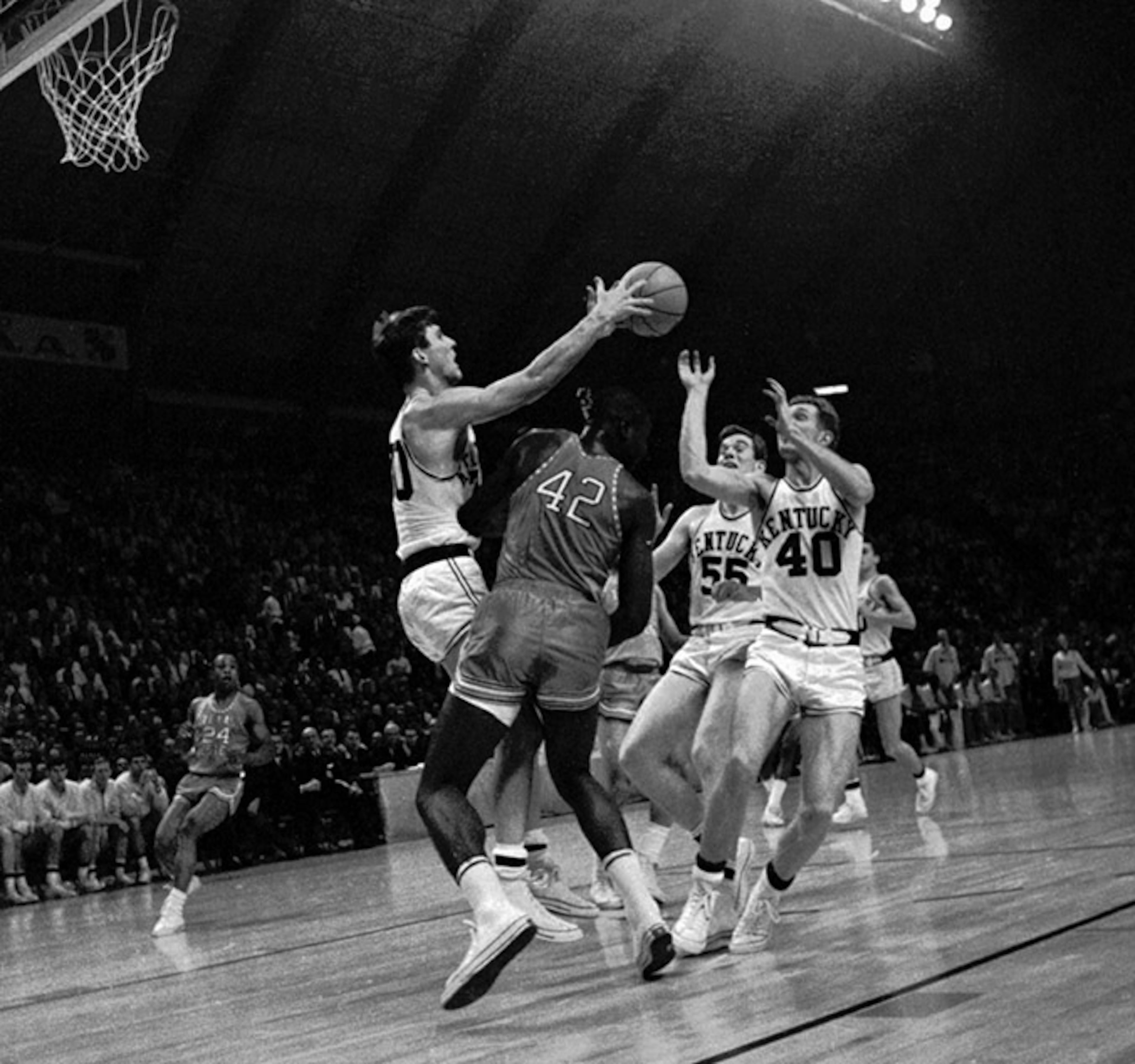 Kentucky's Tommy Kron (left) passes over Texas Western's David Lattin (42) to teammate Larry Conley (40) during the first half of the 1966 college basketball championship game at the University of Maryland in College Park, Md. Texas Western start five black players Lattin, Willie Worsley, Orsten Artis, Bobby Joe Hill and Harry Flournoy against Kentucky.