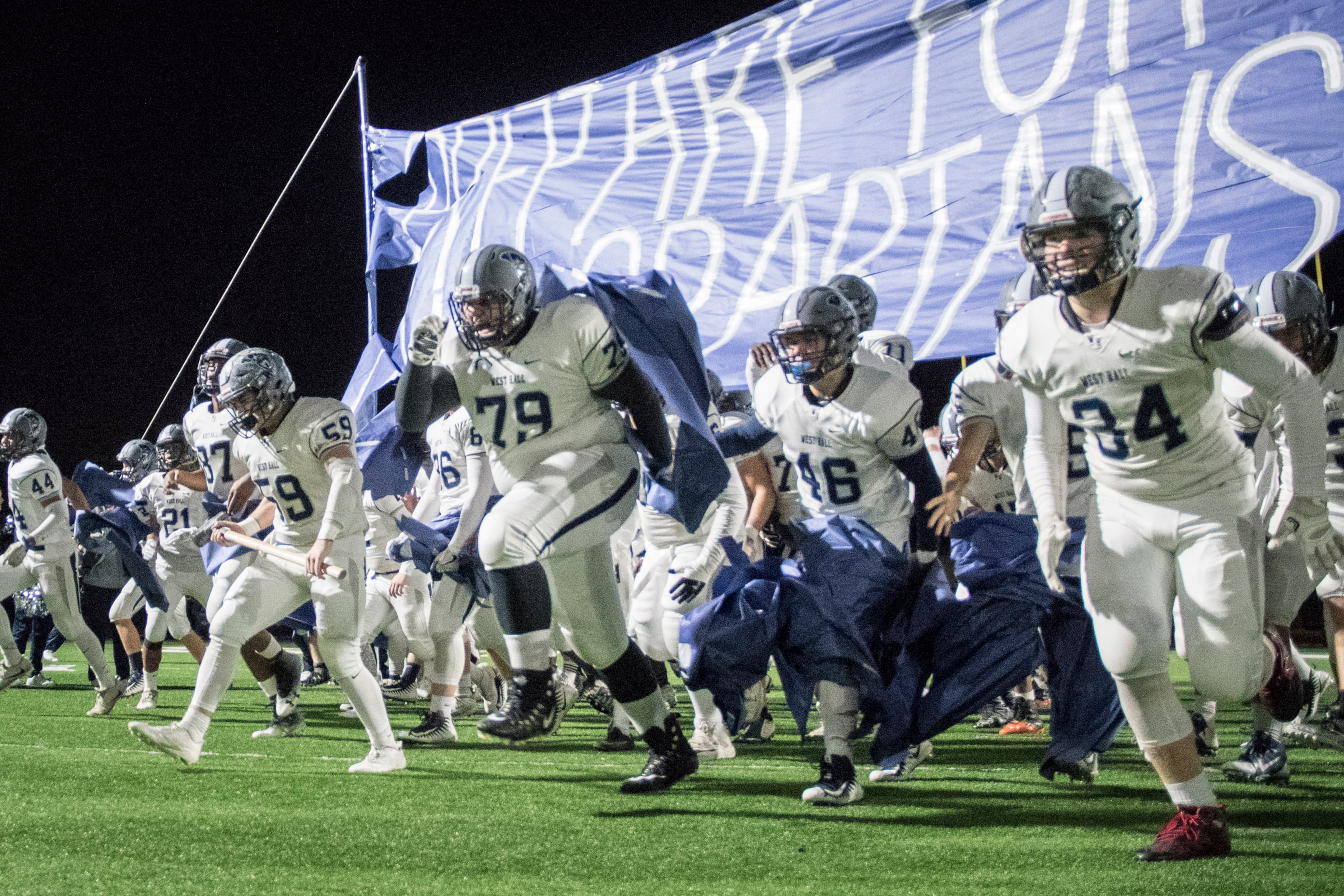 West Hall players burst onto the field before a first round of state playoff football game against St Pius X, Friday, Nov. 10, 2017, in Chamblee. (John Amis)