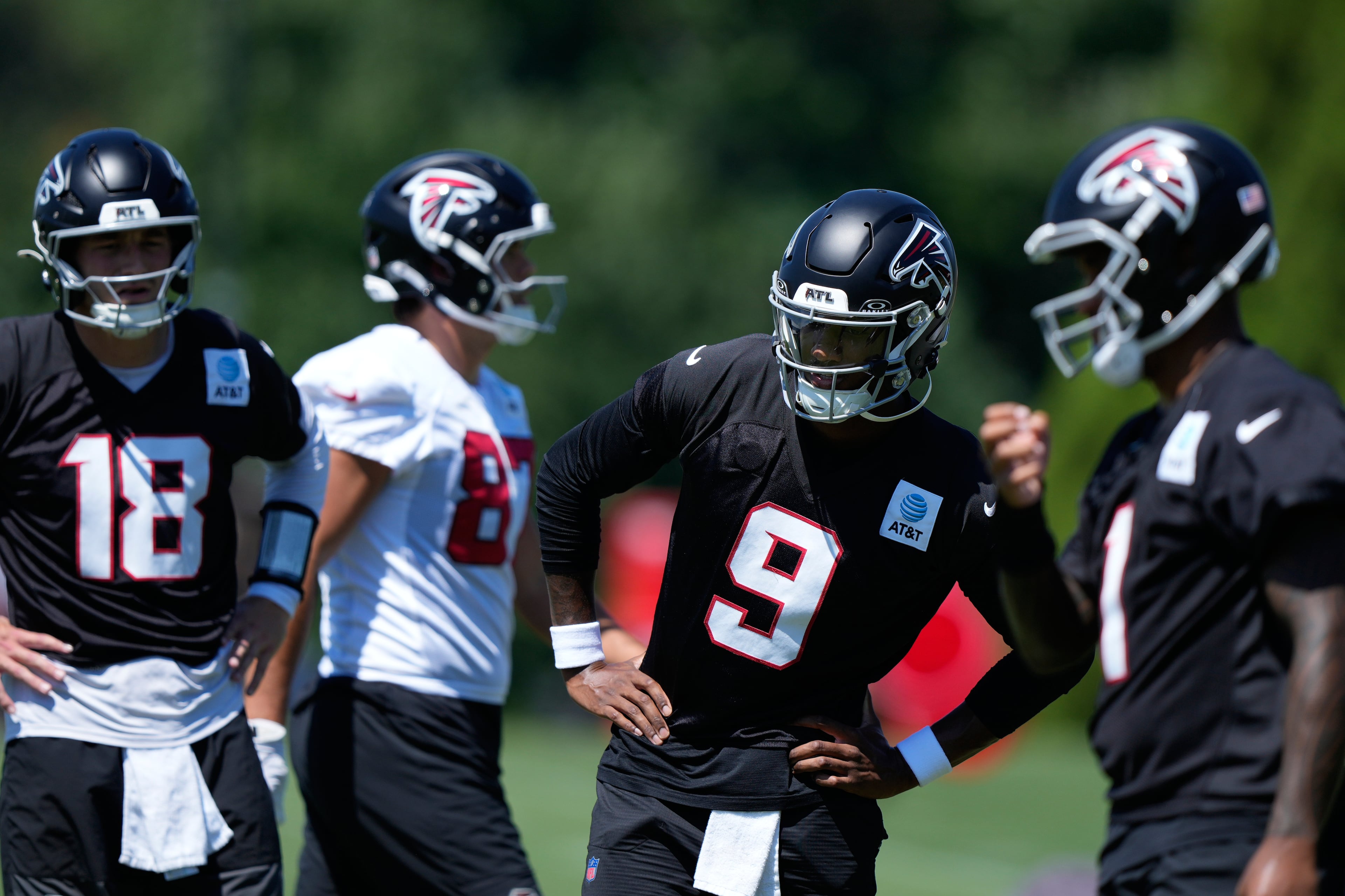 Falcons quarterbacks Jack Strand (from left, in black), Michael Penix Jr. and Tua Tagovailoa. (Brynn Anderson/AP)