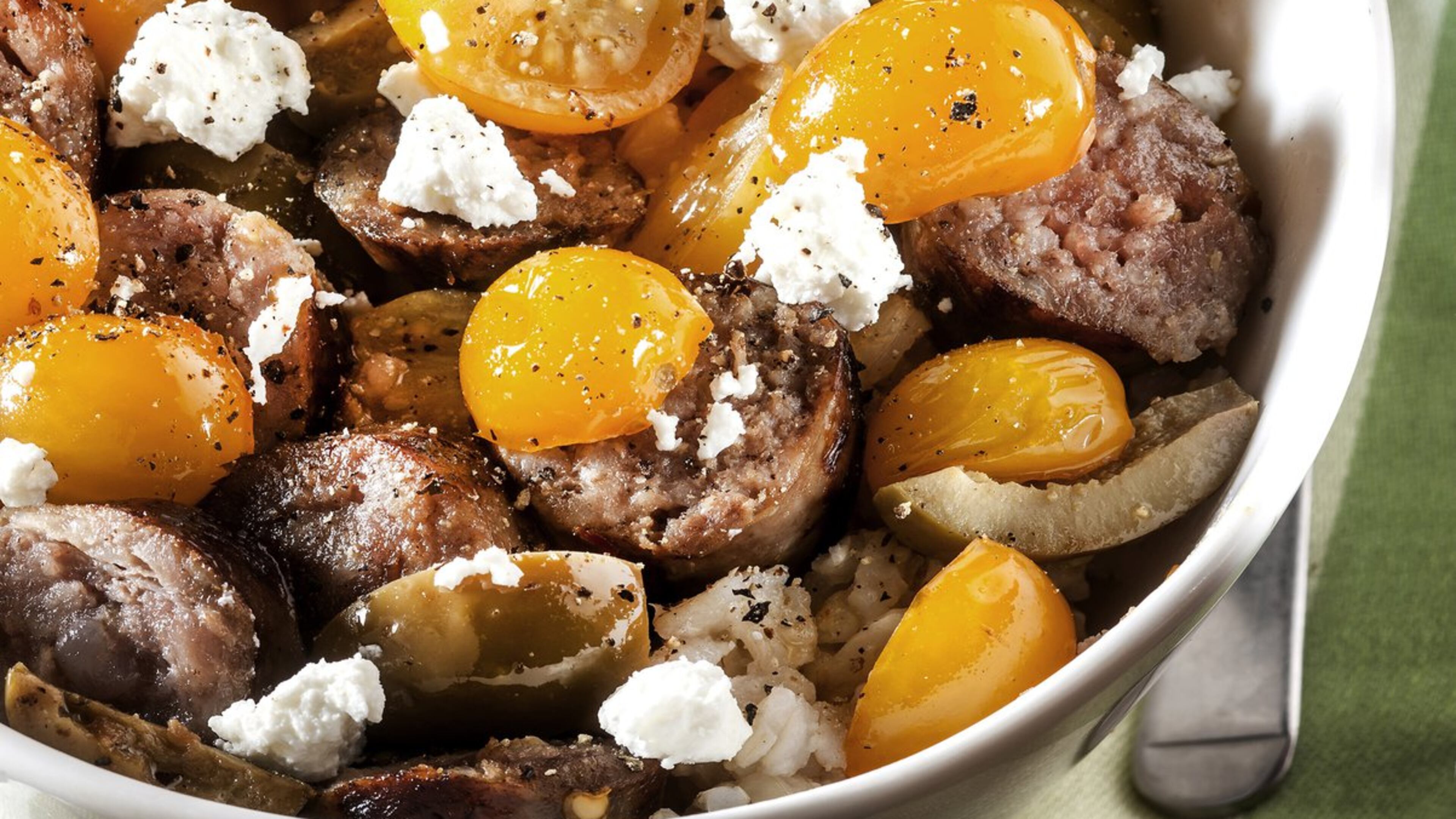 Sweet-as-candy Sun Gold tomatoes offer contrast to the richness of Italian sausage and goat cheese. (Bill Hogan/Chicago Tribune/TNS)