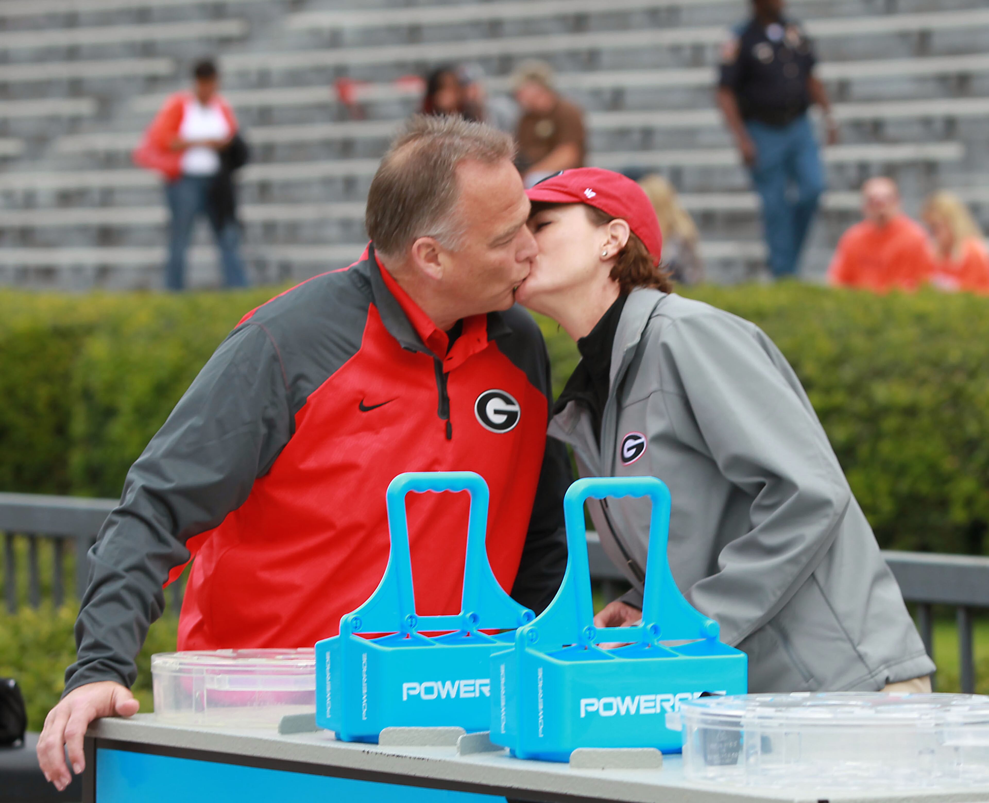 Georgia Bulldogs coach Mark Richt, left, kisses his wife Katharyn before Georgia's game against the Auburn Tigers at Jordan-Hare Stadium Saturday afternoon in Auburn, Al., November 16, 2013. Katharyn Richt works at the Georgia water station on the sideline of Georgia football games.