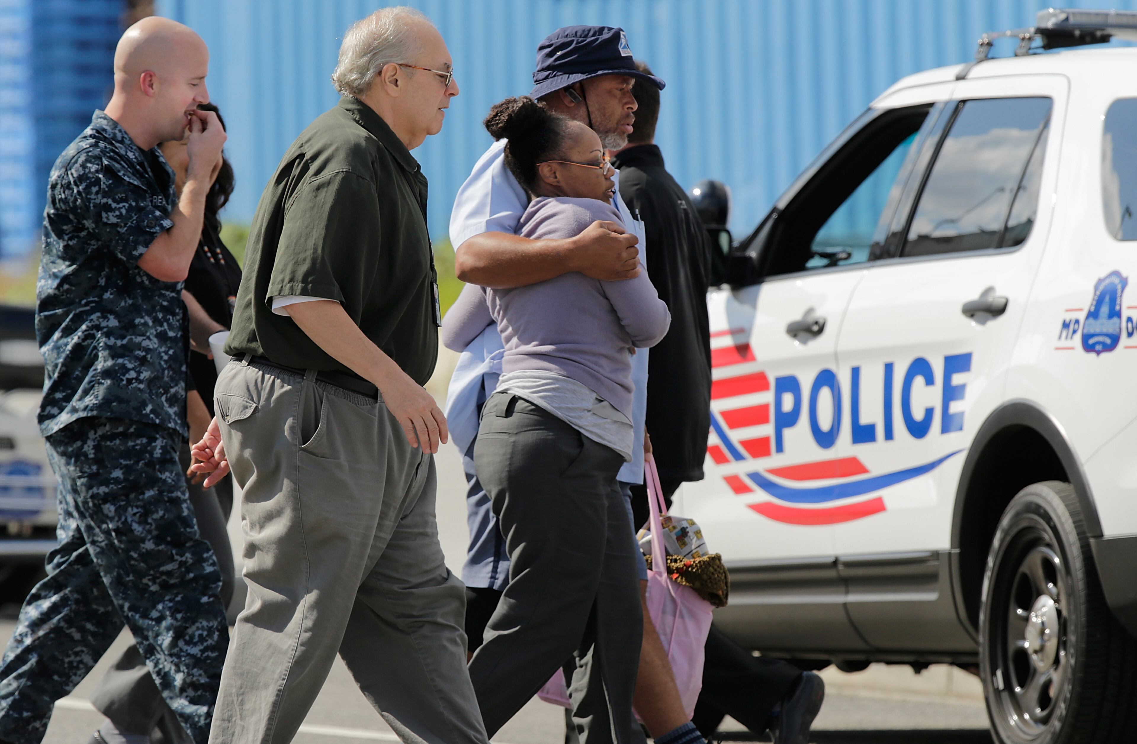 Employees from the Navy Yard complex depart a gathering point for reuniting family members that was set up inside Nationals Park in the wake of the Navy Yard shooting Sept. 16, 2013, in Washington, D.C.