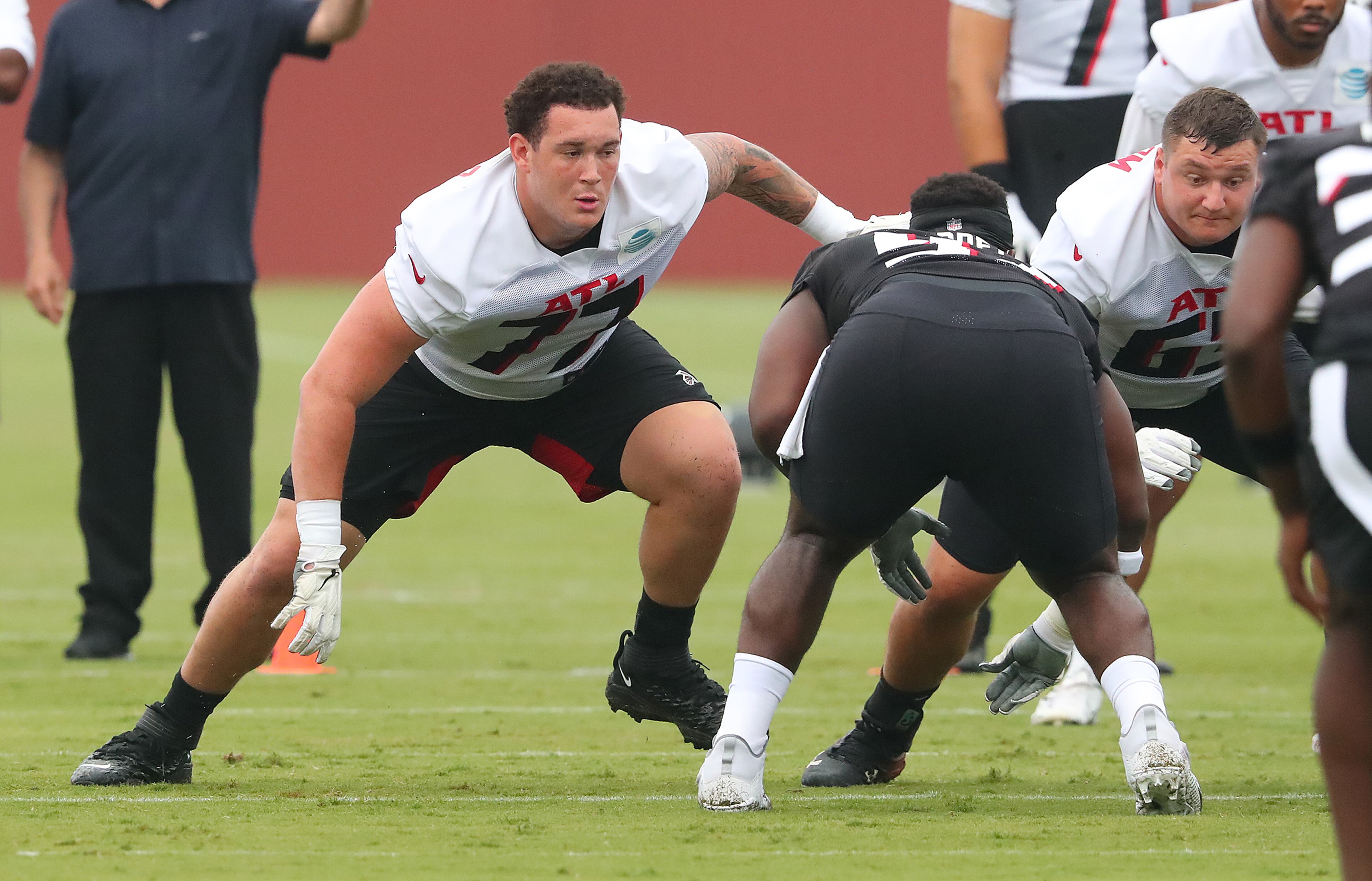 073021 Flowery Branch: Atlanta Falcons offensive lineman Jalen Mayfield (left), the team's third round draft pick, gets in some work next to Chris Lindstrom the second day of training camp practice at the team training facility on Friday, July 30, 2021, in Flowery Branch. “Curtis Compton / Curtis.Compton@ajc.com”