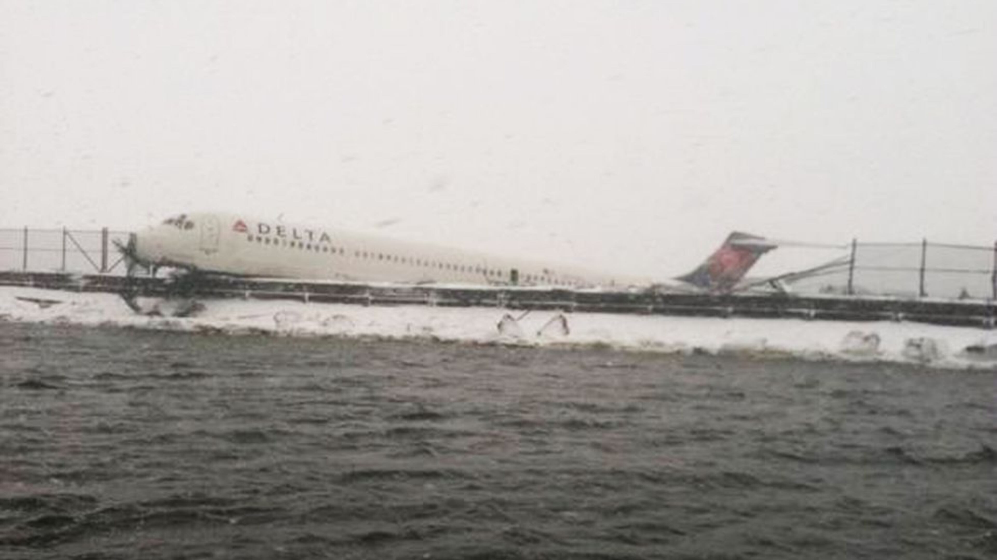 Delta Air Lines Flight 1086 is seen after it slid off the runway upon landing at New York's LaGuardia Airport March 5, 2015. The Delta Air Lines jetliner landing during a snowstorm at New York's LaGuardia Airport on Thursday slid off the runway and struck a fence before coming to rest at the edge of Flushing Bay, but there were no serious injuries.