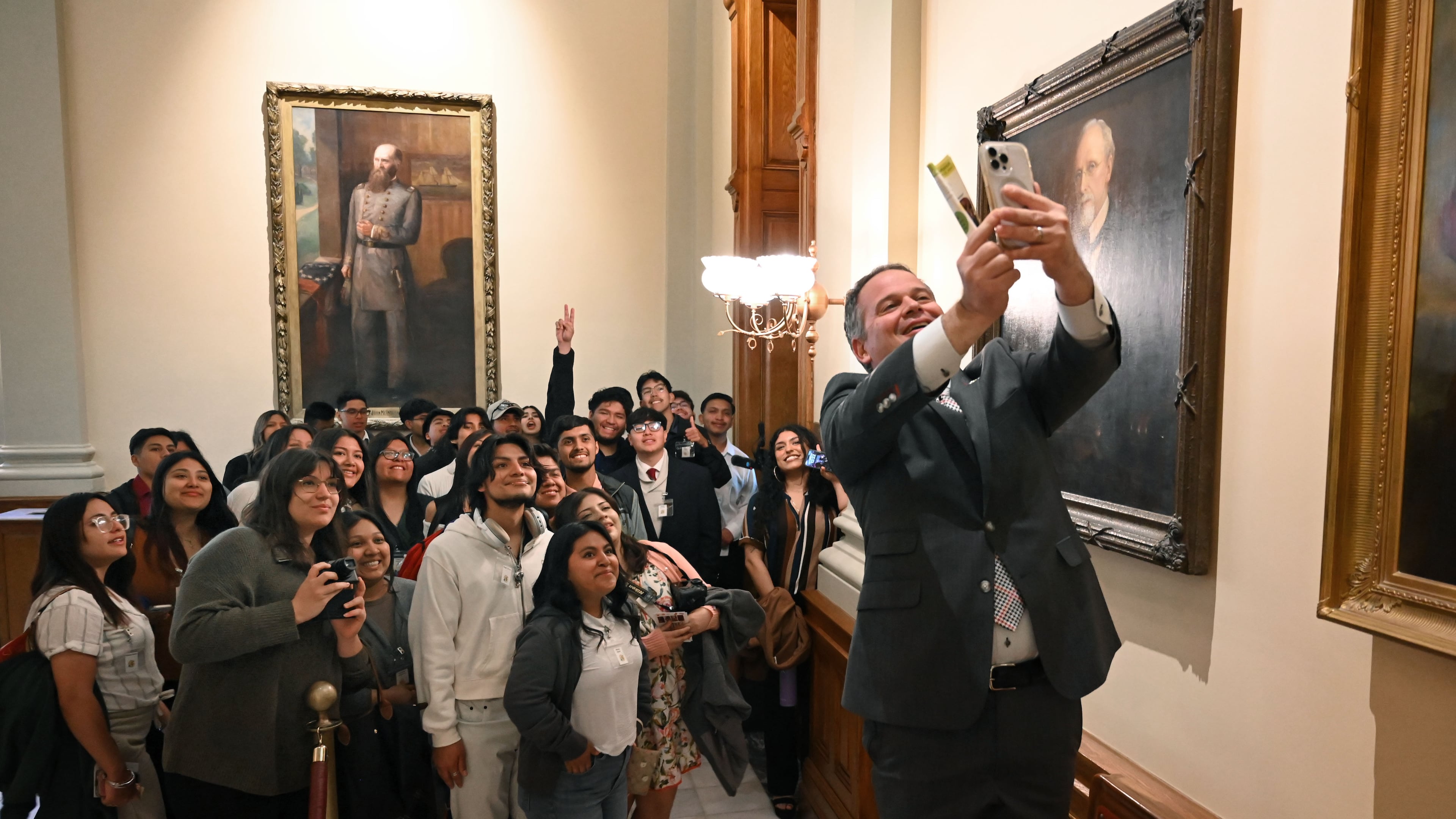 State Sen. Drew Echols (right) takes a selfie with Latino students and children as they visit the Georgia state Capitol in 2025. Latinos are 16% of Georgia’s K-12 students. (Hyosub Shin/AJC)