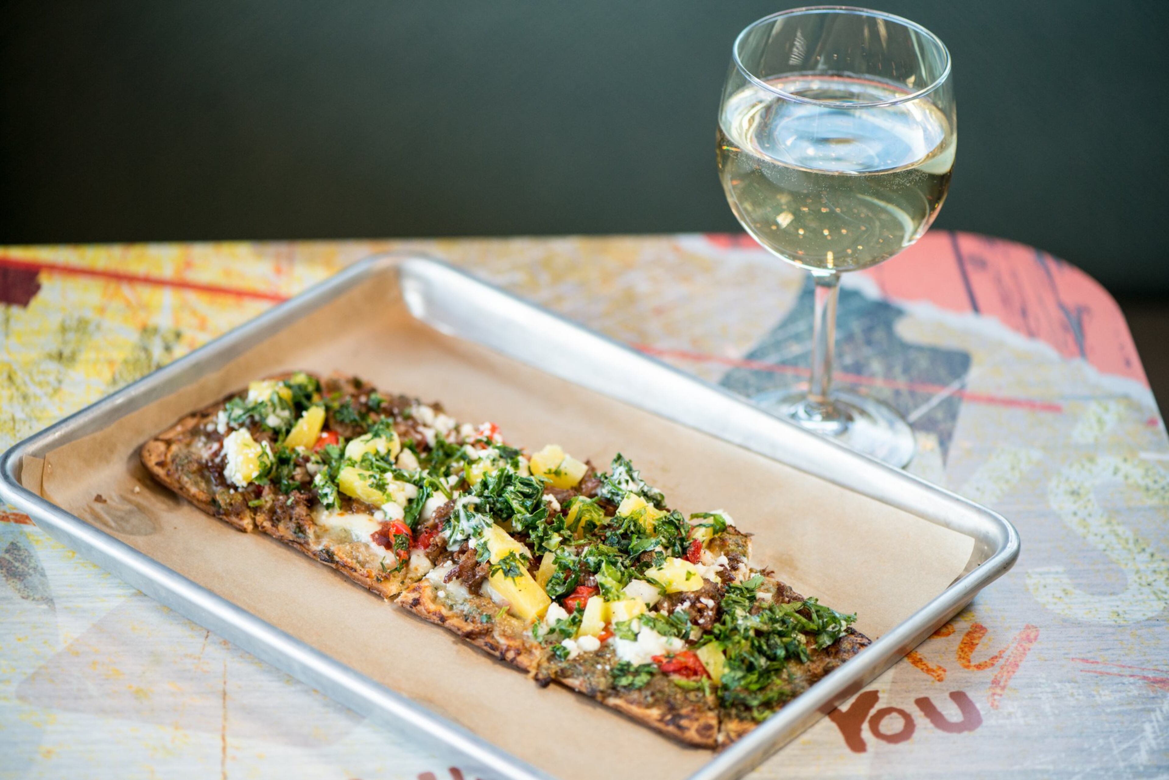 Clarksville Flatbread with brisket, pineapple and kale slaw. Photo credit- Mia Yakel.