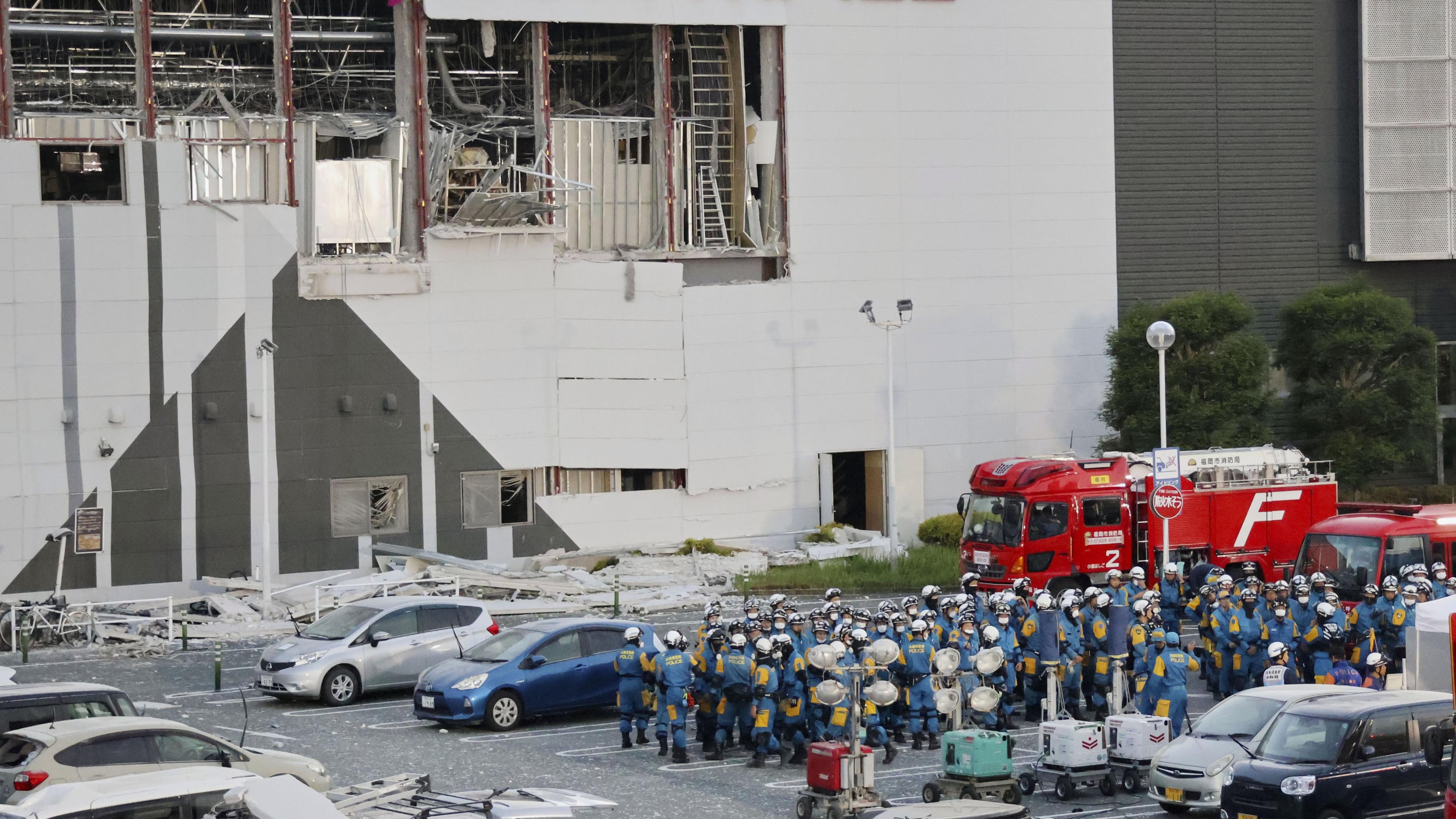 Police units gather in the parking lot before beginning operations at Aeon Mall Kumamoto in Kashima, Kumamoto Prefecture, Friday, July 31, 2026. (Kyodo News via AP)
