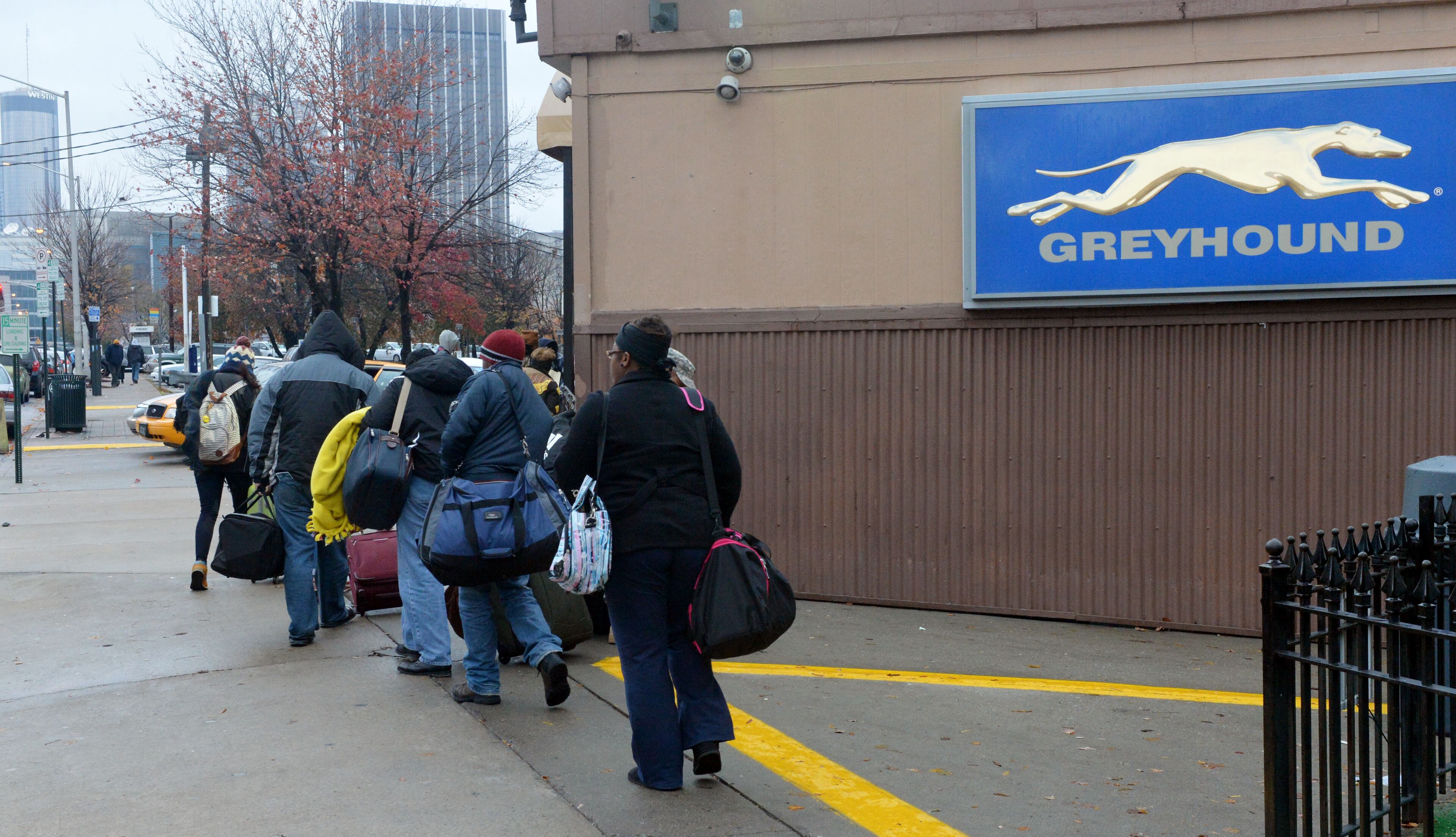 Holiday travelers arrive at the Greyhound bus station in downtown Atlanta, on the day before Thanksgiving, Wednesday, November 27, 2013. Blustery winds and cold temperatures had many travelers bundled up against the pre-holiday weather. KENT D. JOHNSON / KDJOHNSON@AJC.COM