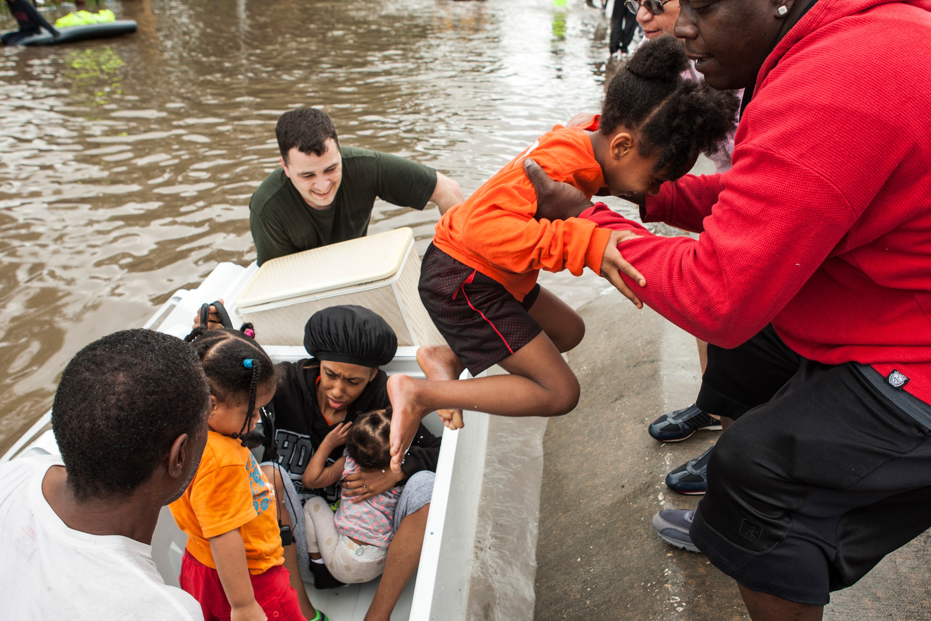 Residents of the Arbor Court apartments evacuate their flooded apartment complex in a refrigerator on Monday, April 18, 2016, in The Woodlands, Texas. (Brett Coomer/Hoston Chronicle via AP)