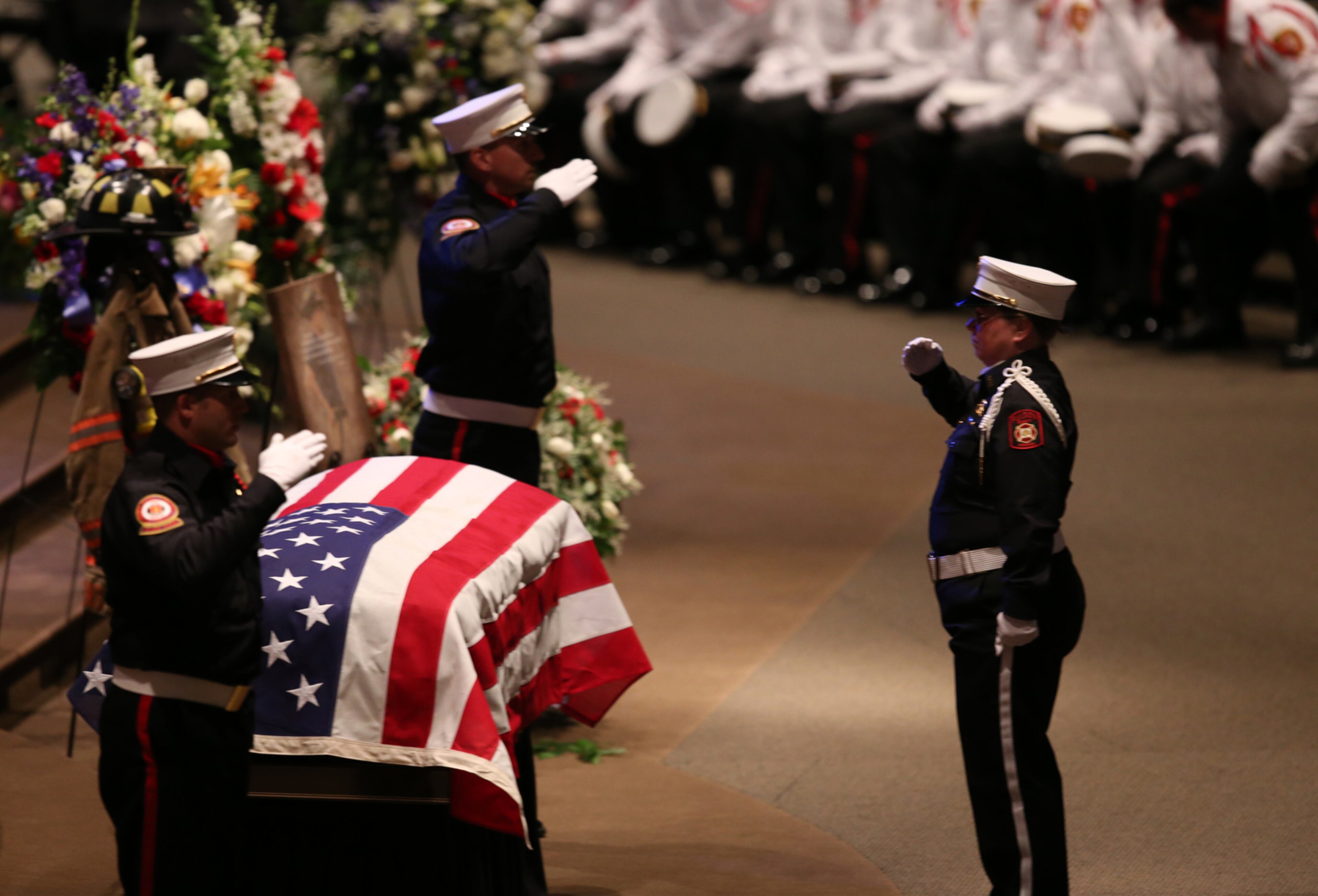 April 19, 2017, Atlanta, Georgia - Officers salute one another during the changing of the guard at the funeral service of Ron Herens at Trinity Chapel in Powder Springs, Georgia, on April 19, 2017. A Celebration of Life funeral service was held for Marietta Fire Fighter Ron Herens, who died in a traffic accident while on vacation in Los Angeles last week. (HENRY TAYLOR / HENRY.TAYLOR@AJC.COM)