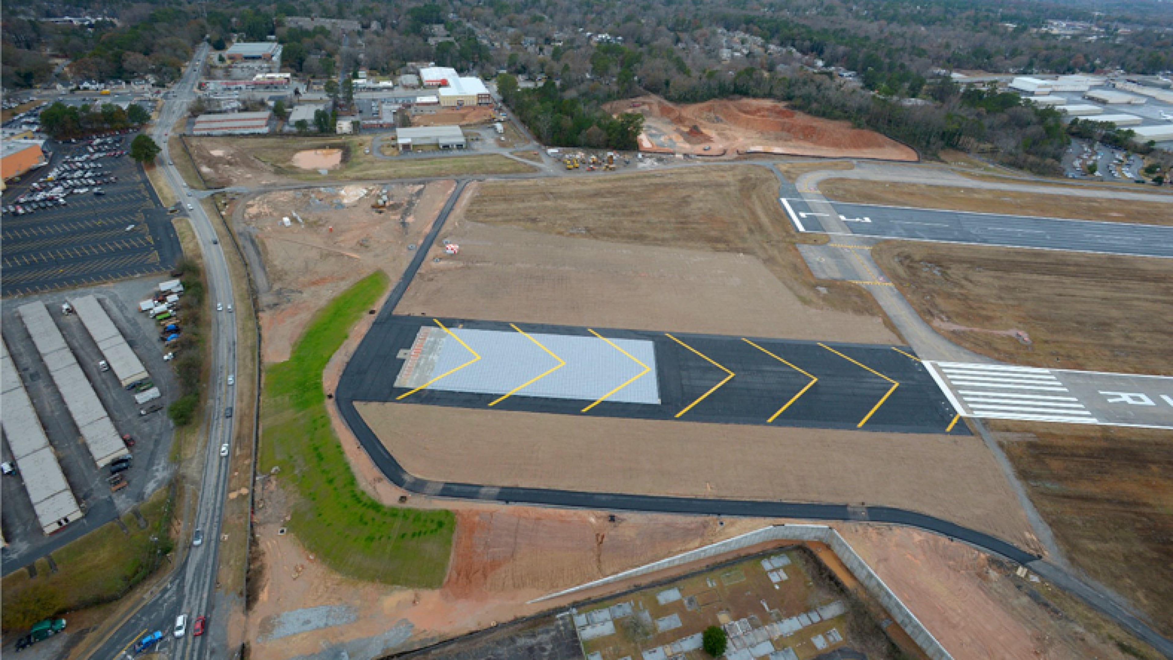 The aircraft stopping safety system at DeKalb Peachtree Airport is the first of its kind in Georgia. The EMAS technology is placed 200 feet off the end of a runway to prevent an aircraft from running off the runway. The gray area inside the black asphalt area is the new EMAS technology on Runway 3R-21L at PDK Airport. CONTRIBUTED