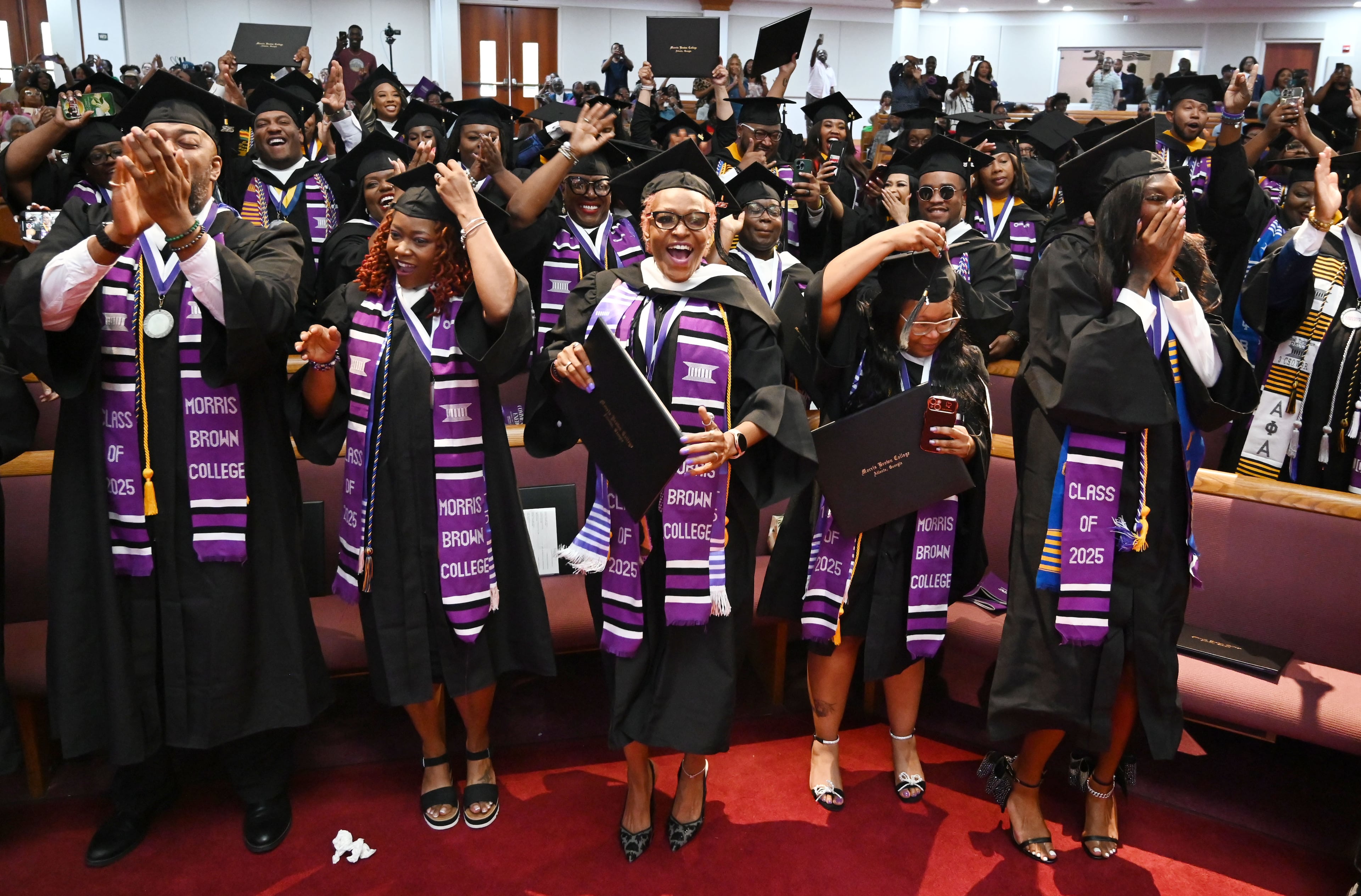Graduates react as they move their tassels during 2025 Morris Brown College commencement exercises at Saint Philip A.M.E. Church, Saturday, May 17, 2025, in Atlanta. (Hyosub Shin / AJC)