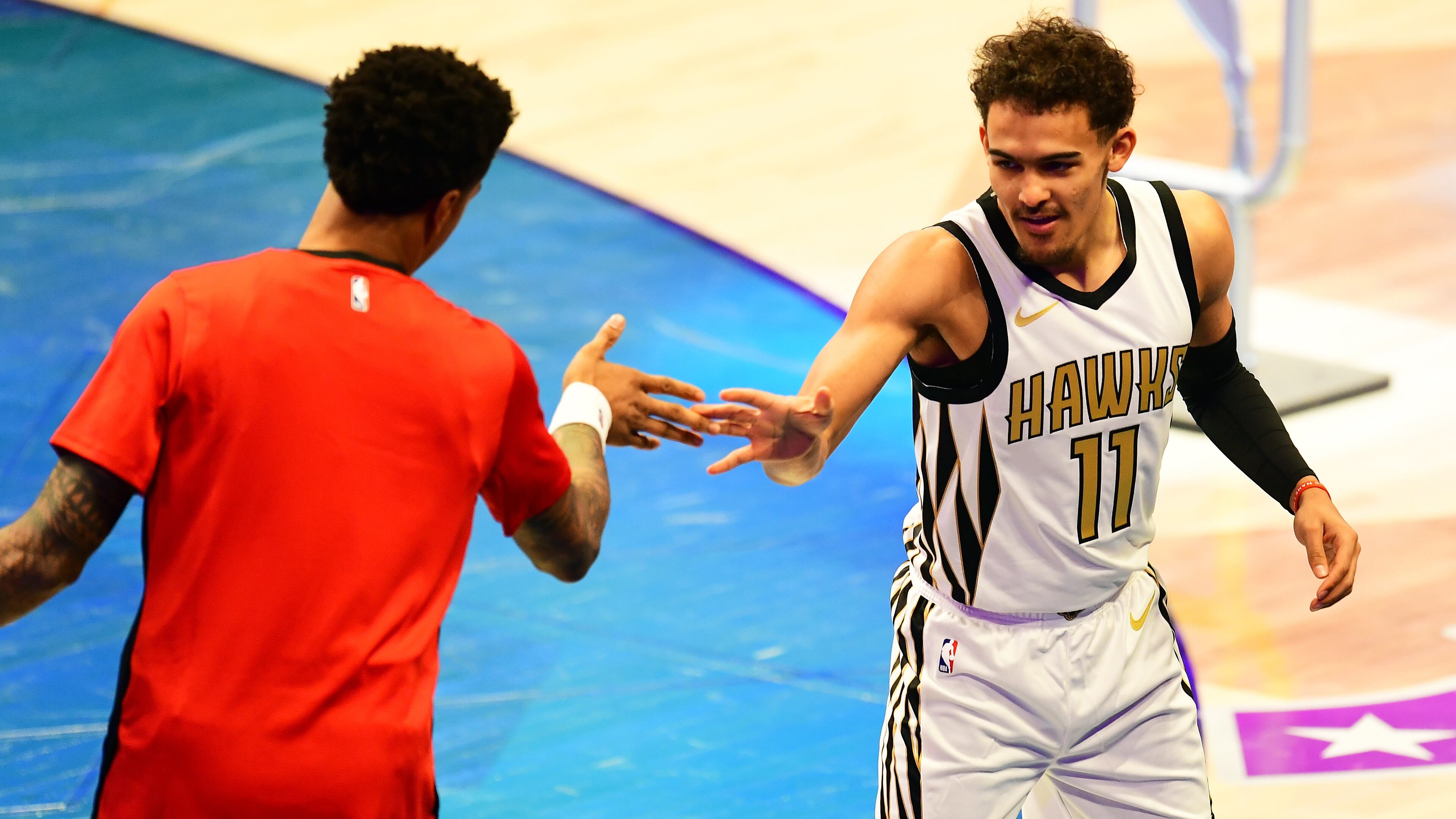 Hawks rookie Trae Young greets teammate John Collins before he competes in the Skills Challenge at All-Star Saturday night. Photo by Scott Cunningham.