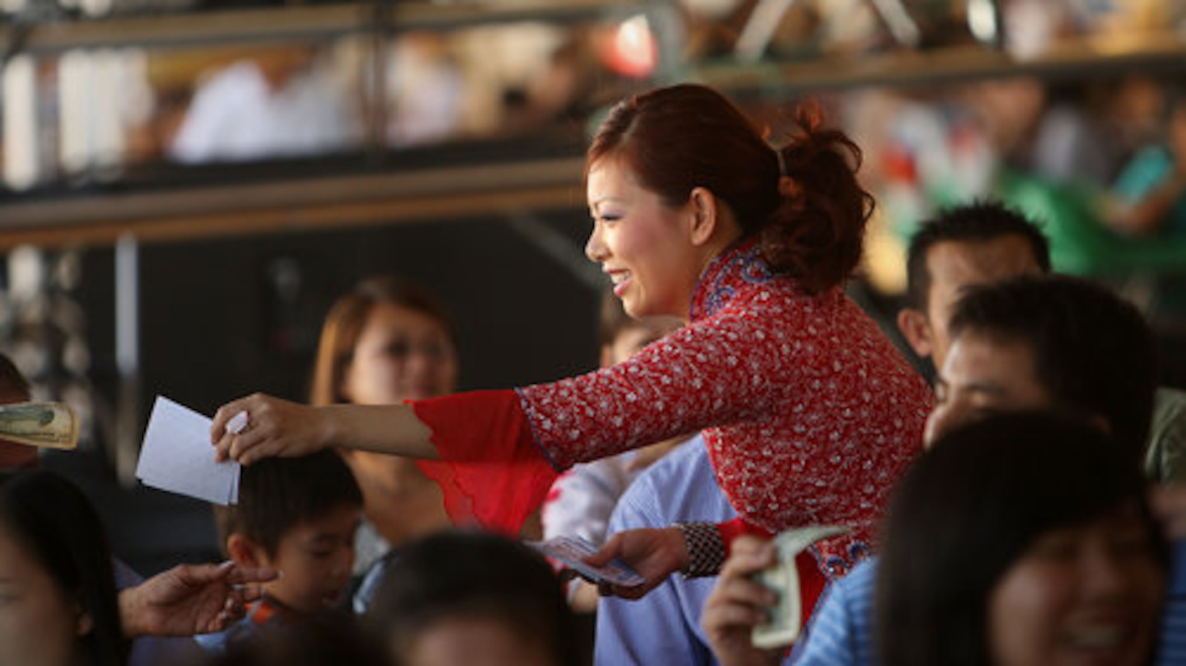 Nhu Quynh Lam sells bingo tickets to raise money to benefit the Church and its ministries. Lam, a member of the church for three years says she hopes the festival will have a taste of Vietnam next year.