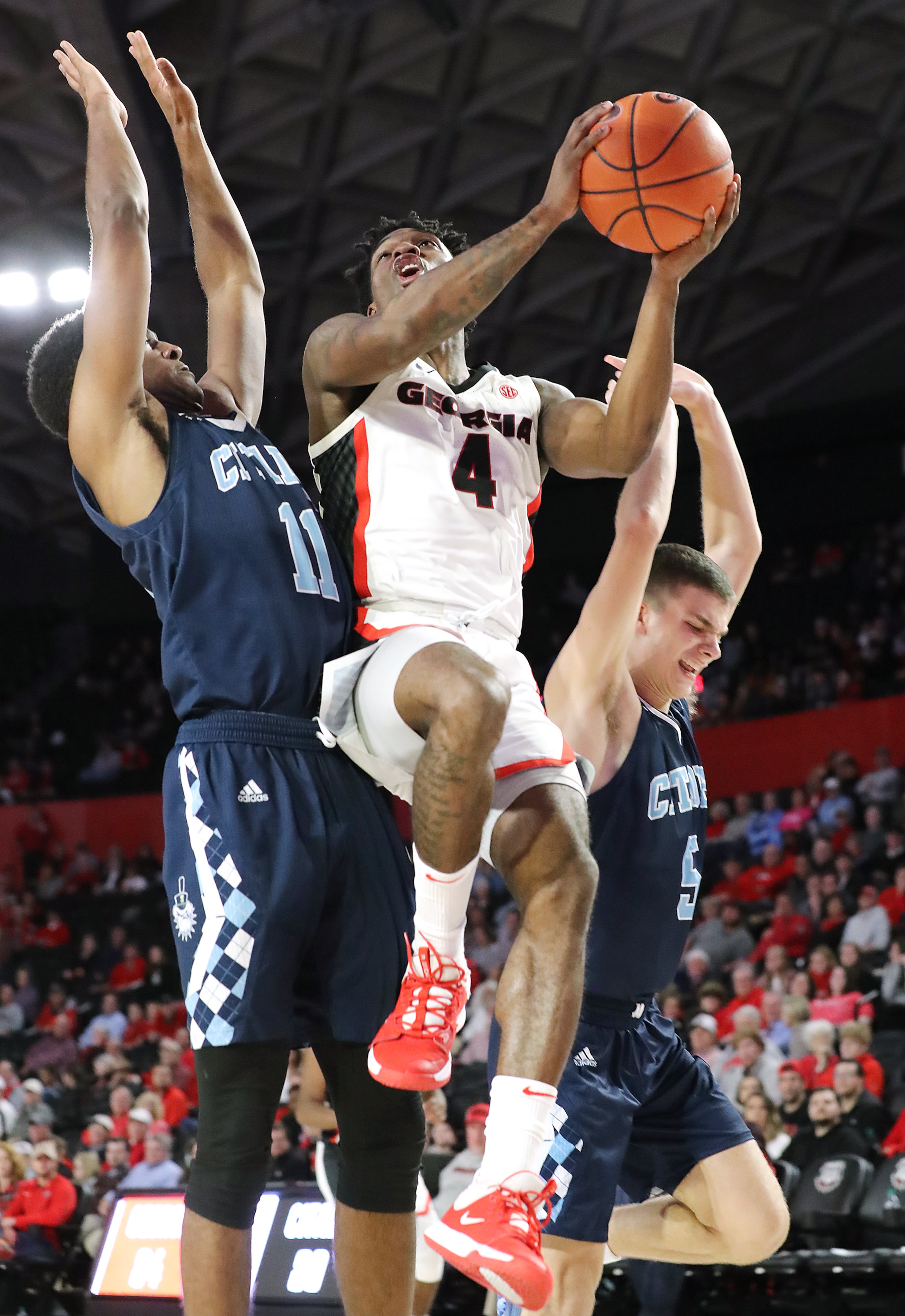 Georgia senior Tyree Crump goes to the basket for two against Citadel guard Kaiden Rice (left) and Fletcher Abee (right) during the second half in a NCAA college basketball game on Tuesday, November 12, 2019, in Athens. Curtis Compton/ccompton@ajc.com