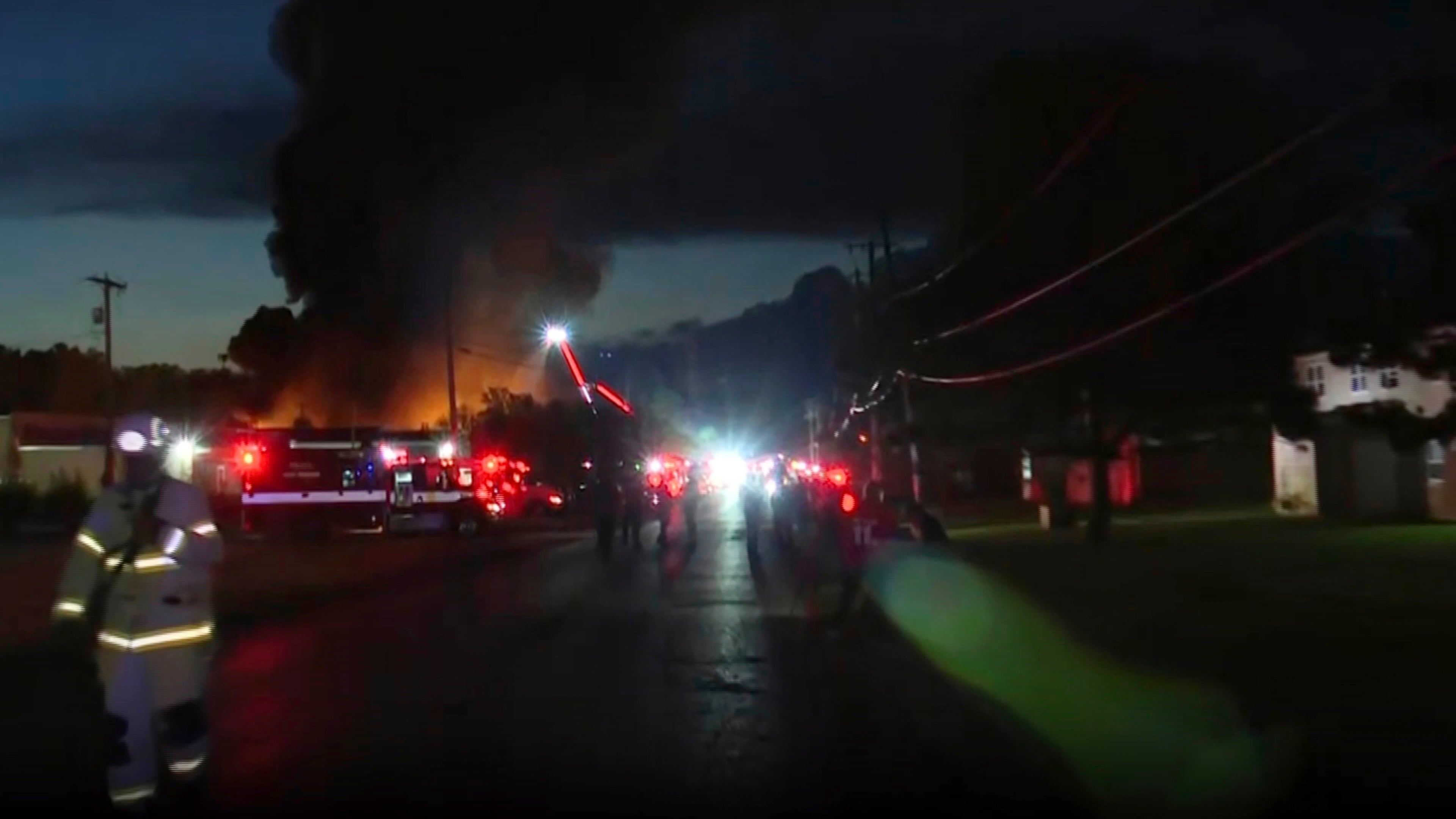 This image taken from video provided by WTVG shows firefighters working on the scene after an explosion at an industrial recycling business in Toledo, Ohio, Tuesday, Aug. 18, 2026. (WTVG via AP)
