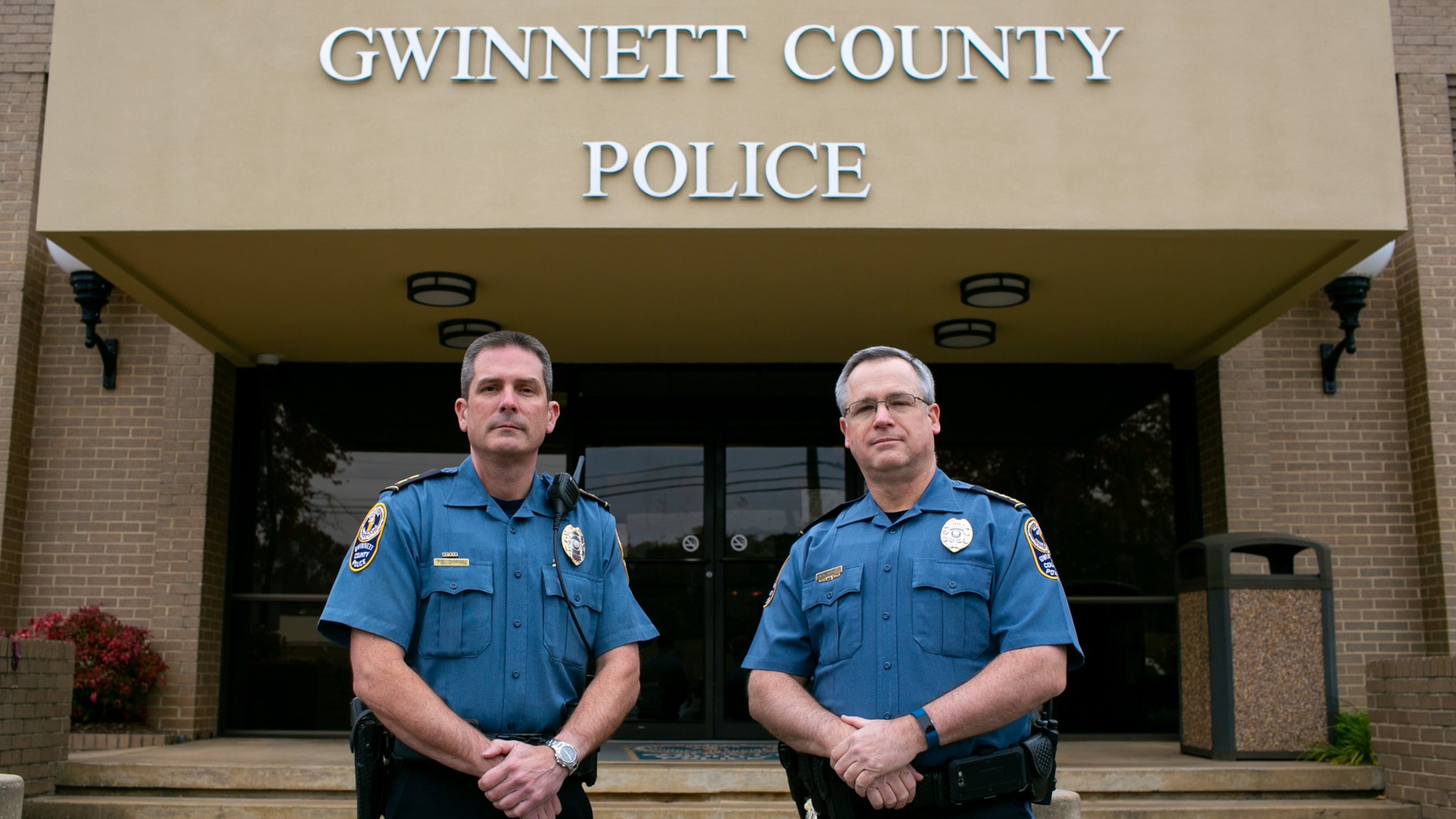 Incoming Gwinnett County police Chief Tom Doran and outgoing Chief Butch Ayers pose outside of the Gwinnett County police headquarters in Lawrenceville on Thursday, Nov. 14, 2019. Ayers retired Nov. 15, after five years in charge and more than three decades with the department. (Rebecca Wright for the Atlanta Journal-Constitution)